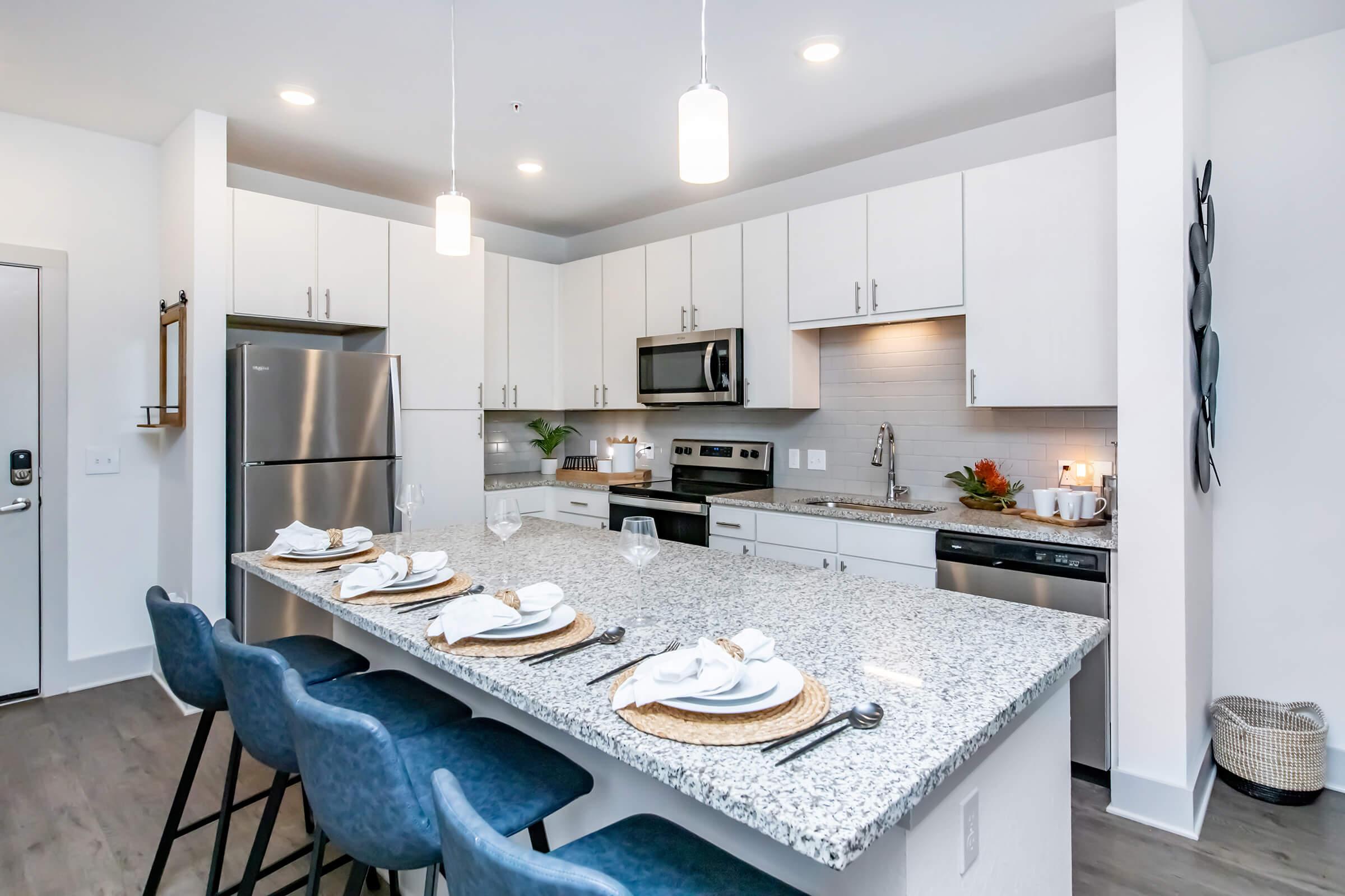 a kitchen with an island in the middle of a table