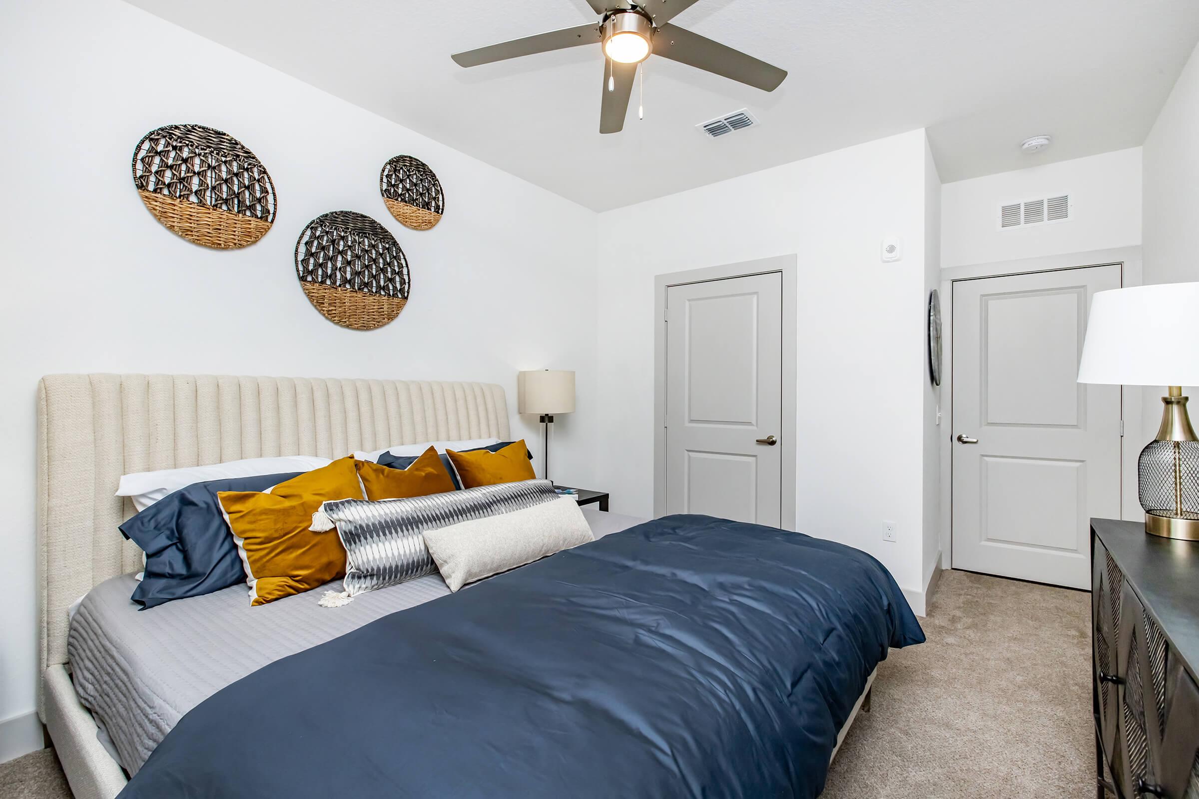 a bedroom with a bed and desk in a room