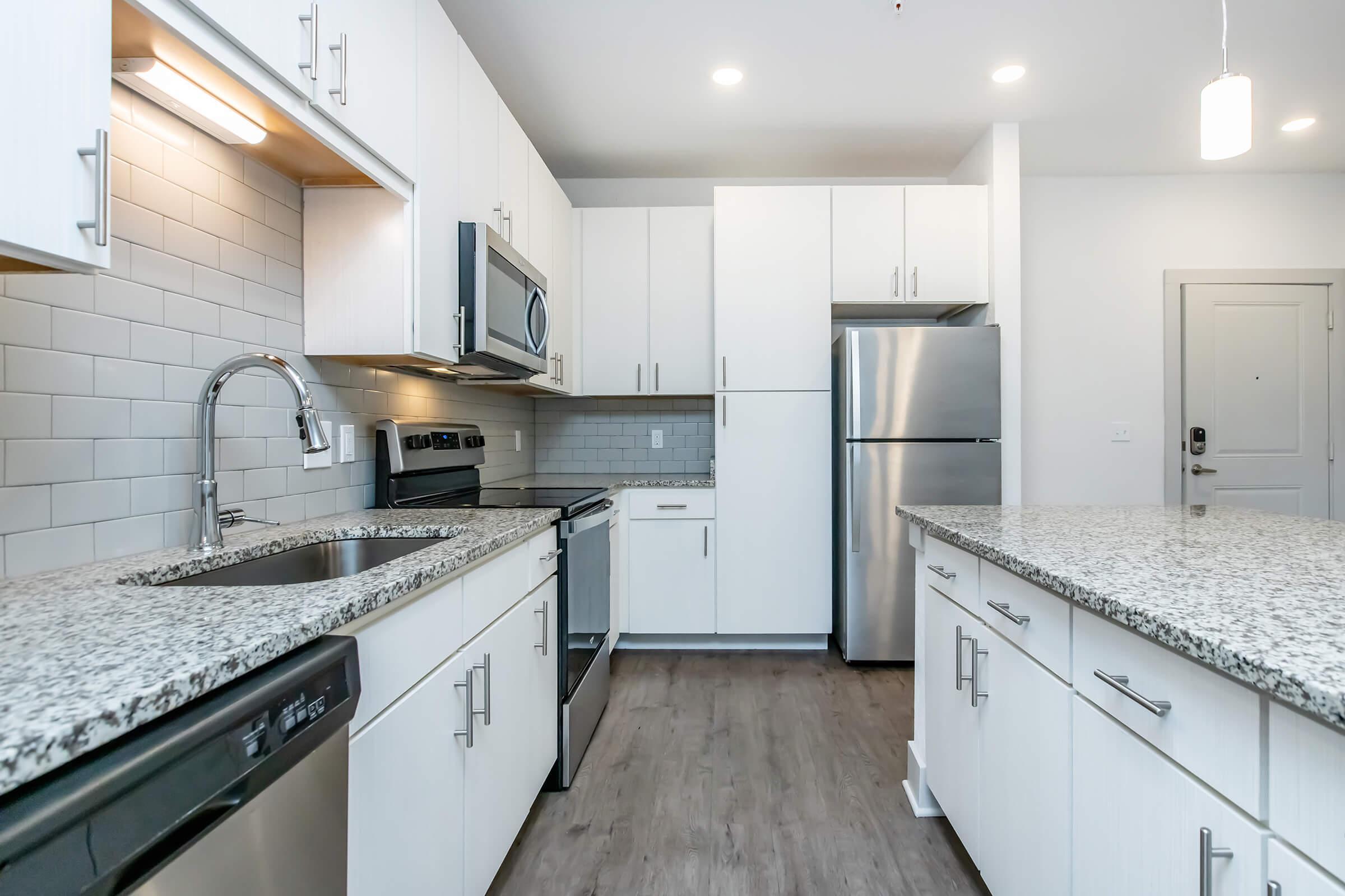 a kitchen with a stove sink and refrigerator