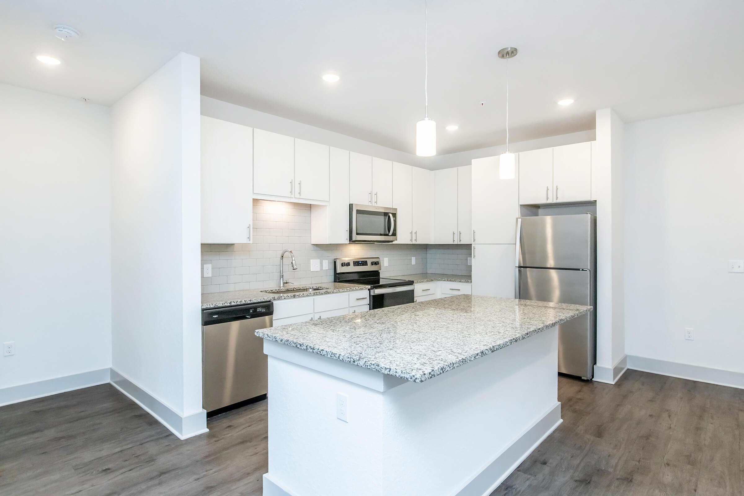 a kitchen with a stove sink and refrigerator