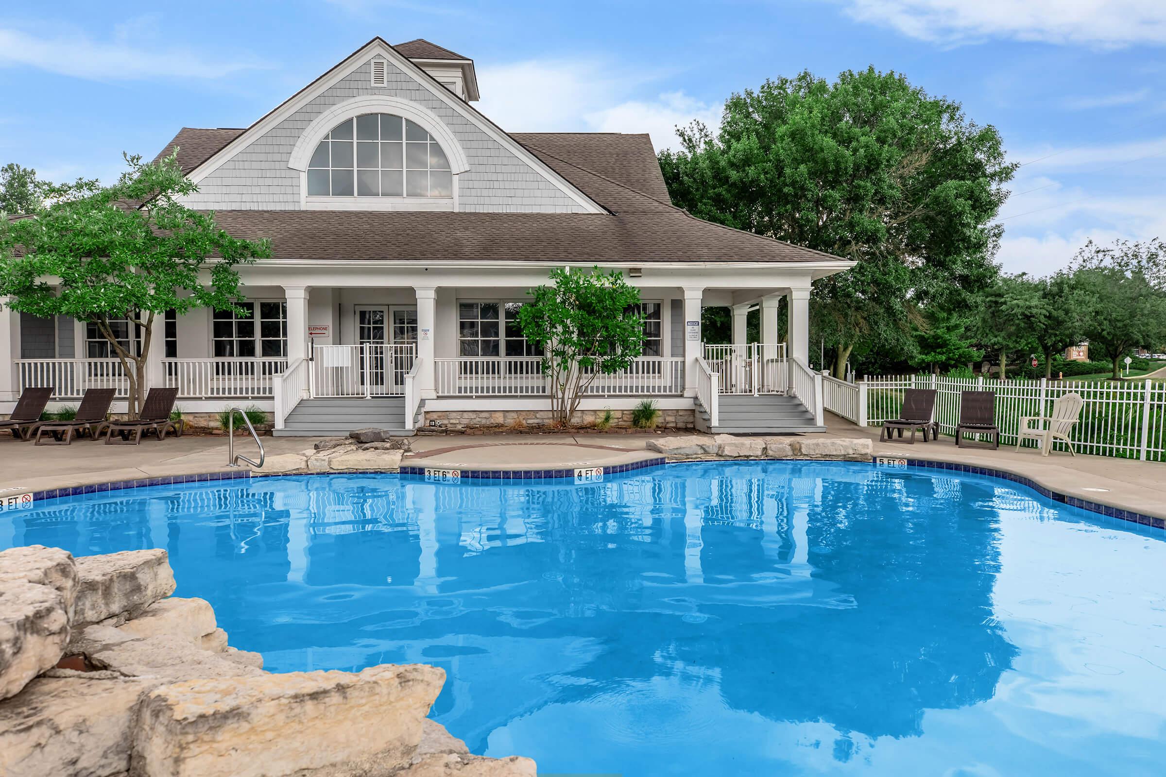 a large pool of water in front of a house