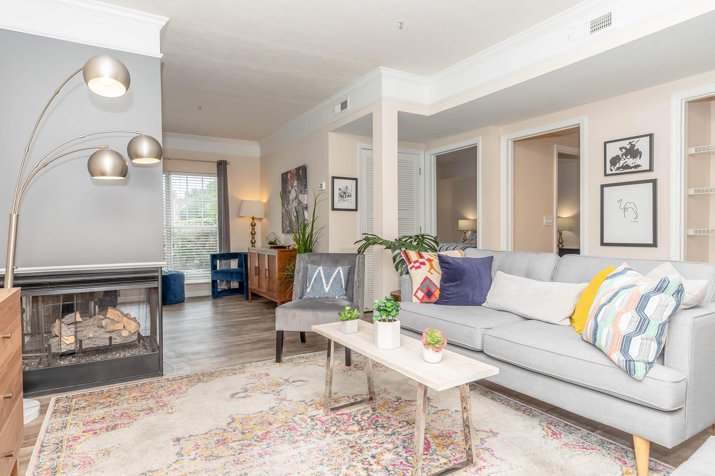 a living room filled with furniture and a fireplace