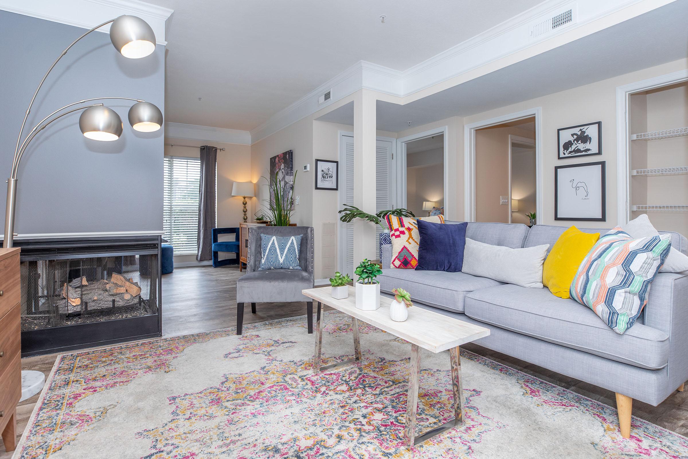 a living room filled with furniture and a fire place