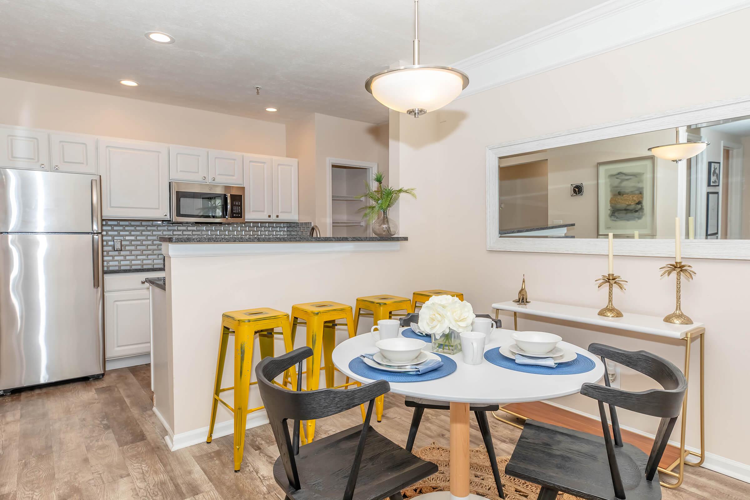 a kitchen with a sink and a chair in a room