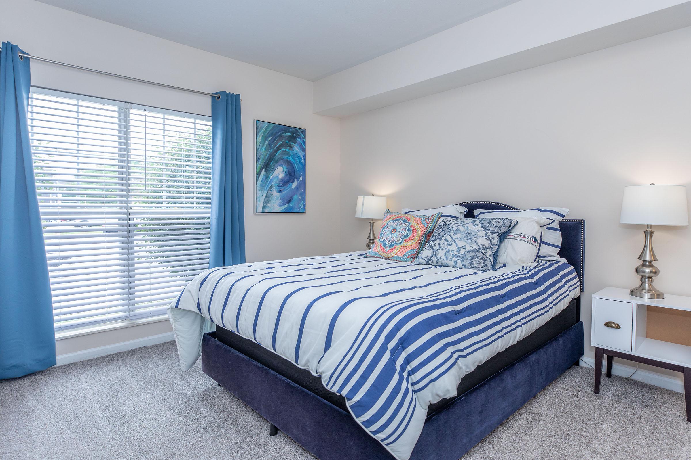 a bedroom with a bed and desk in a room