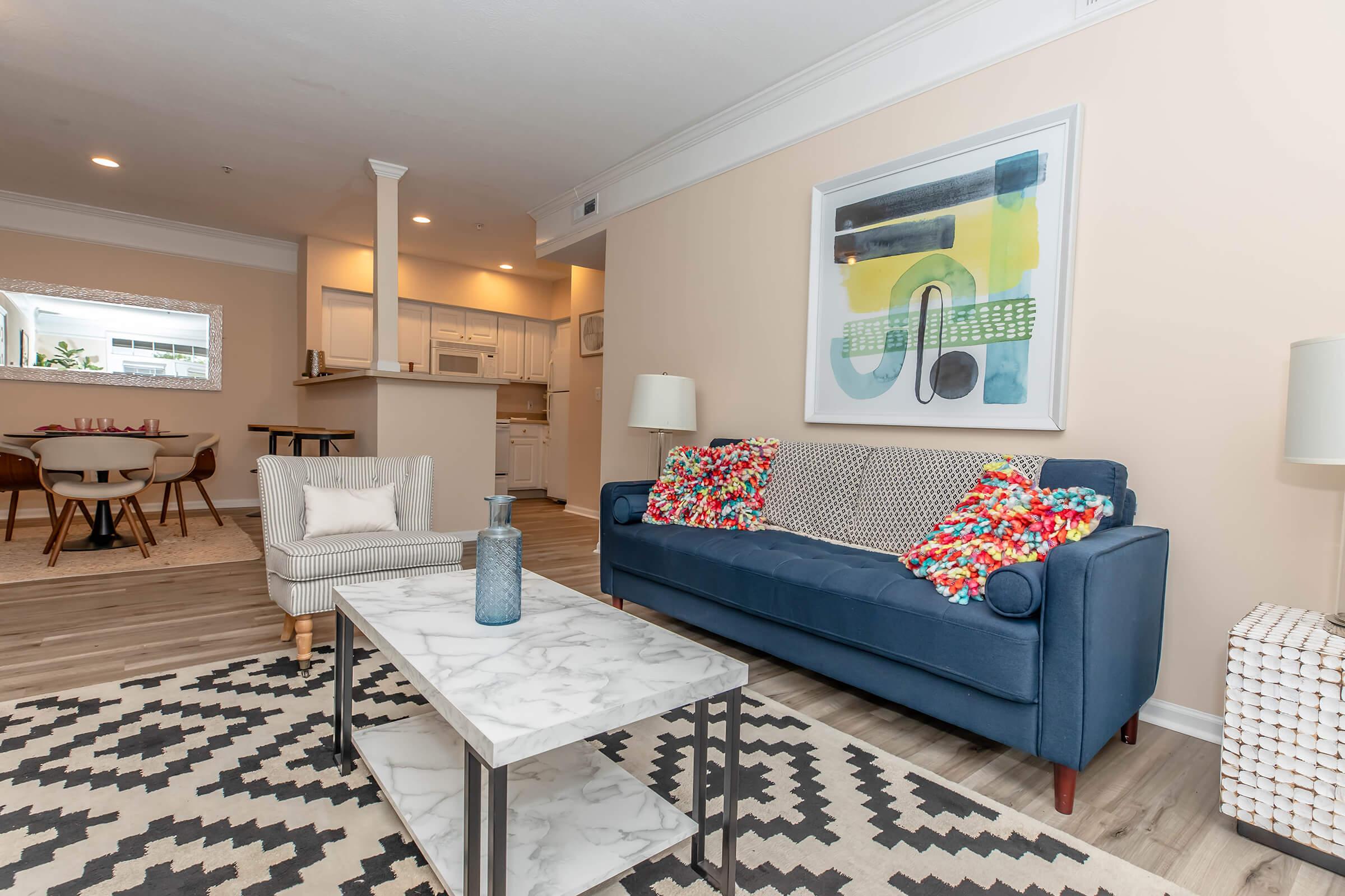 a living room filled with furniture and a flat screen tv