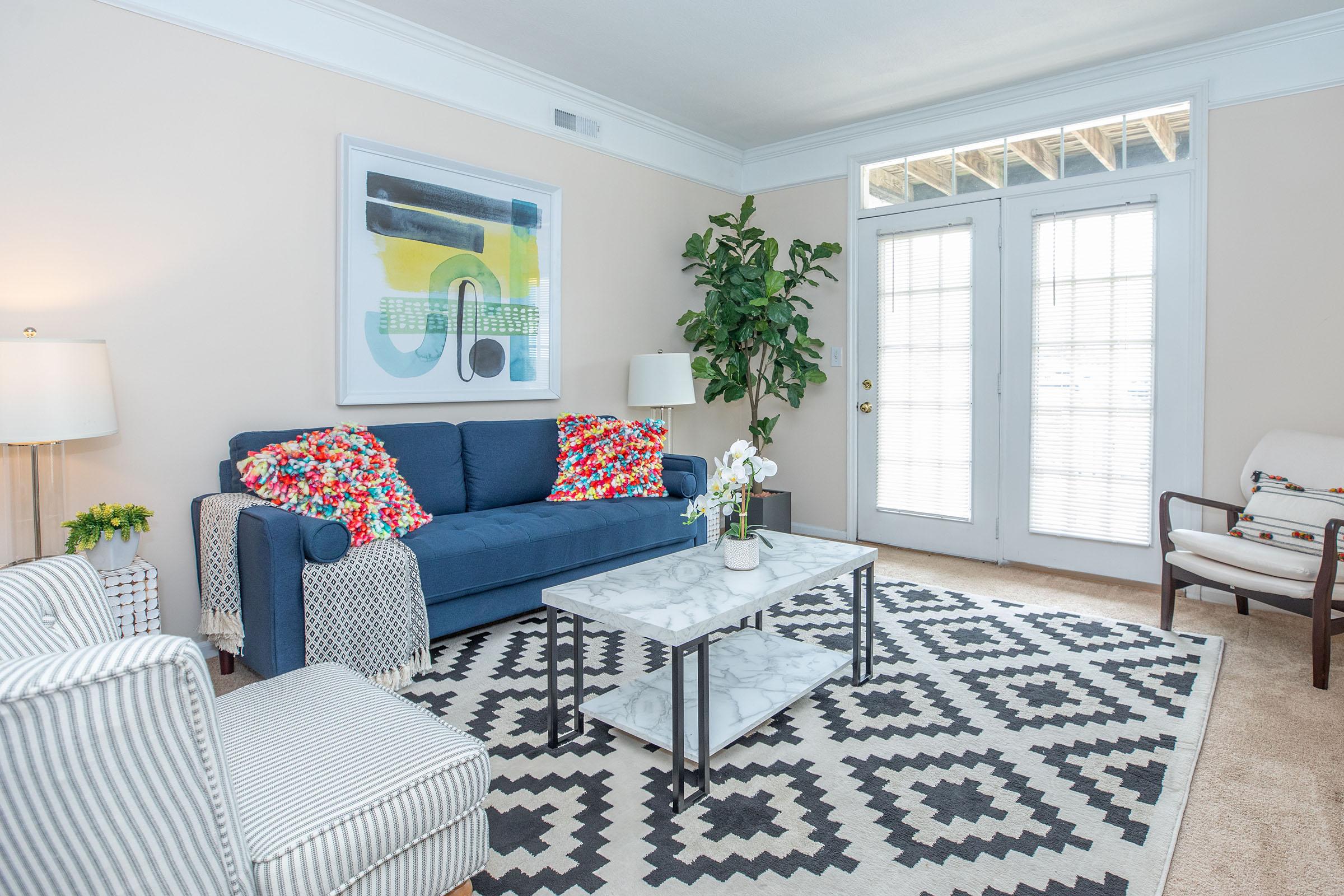 a living room filled with furniture and a rug