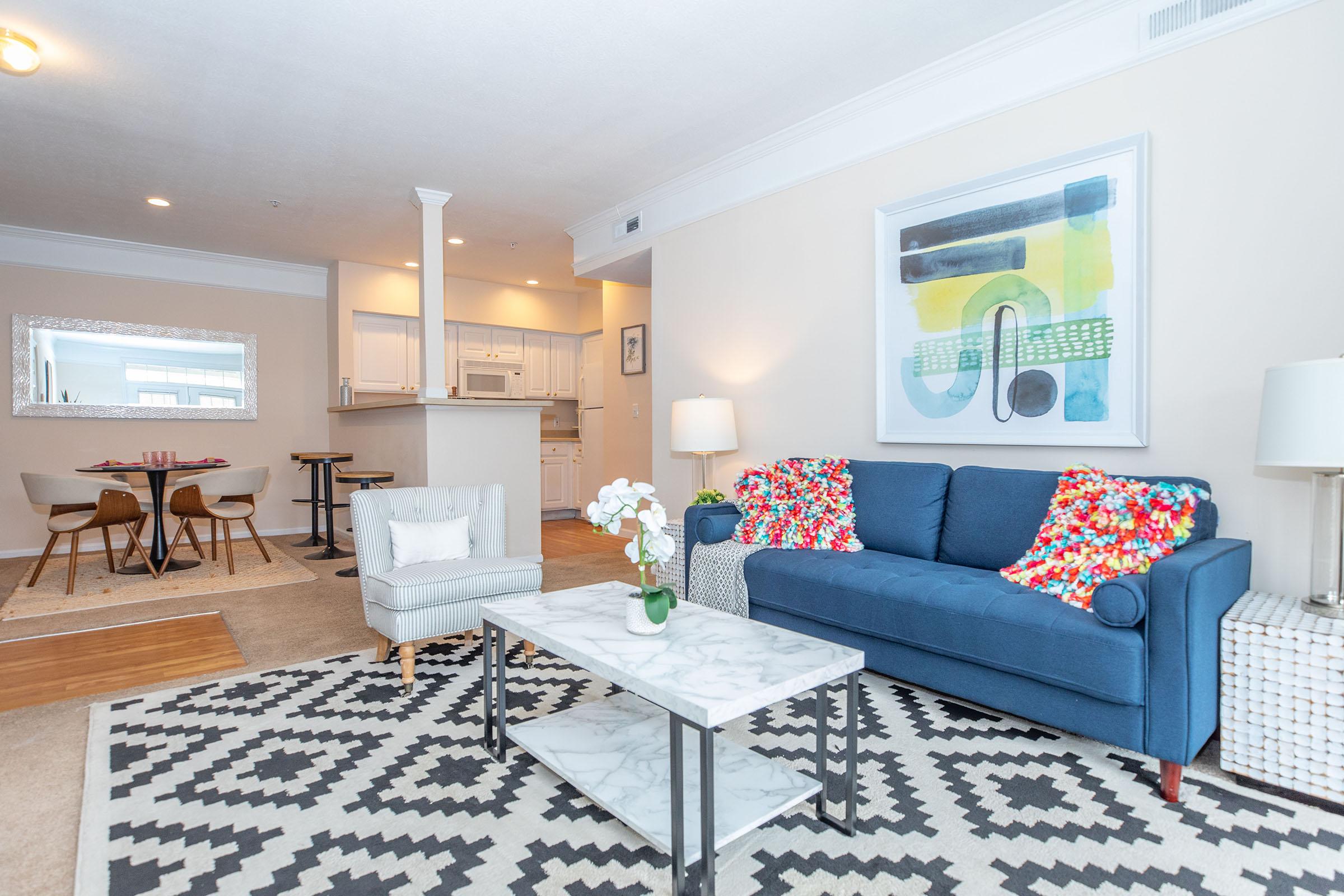 a living room filled with furniture and a large window