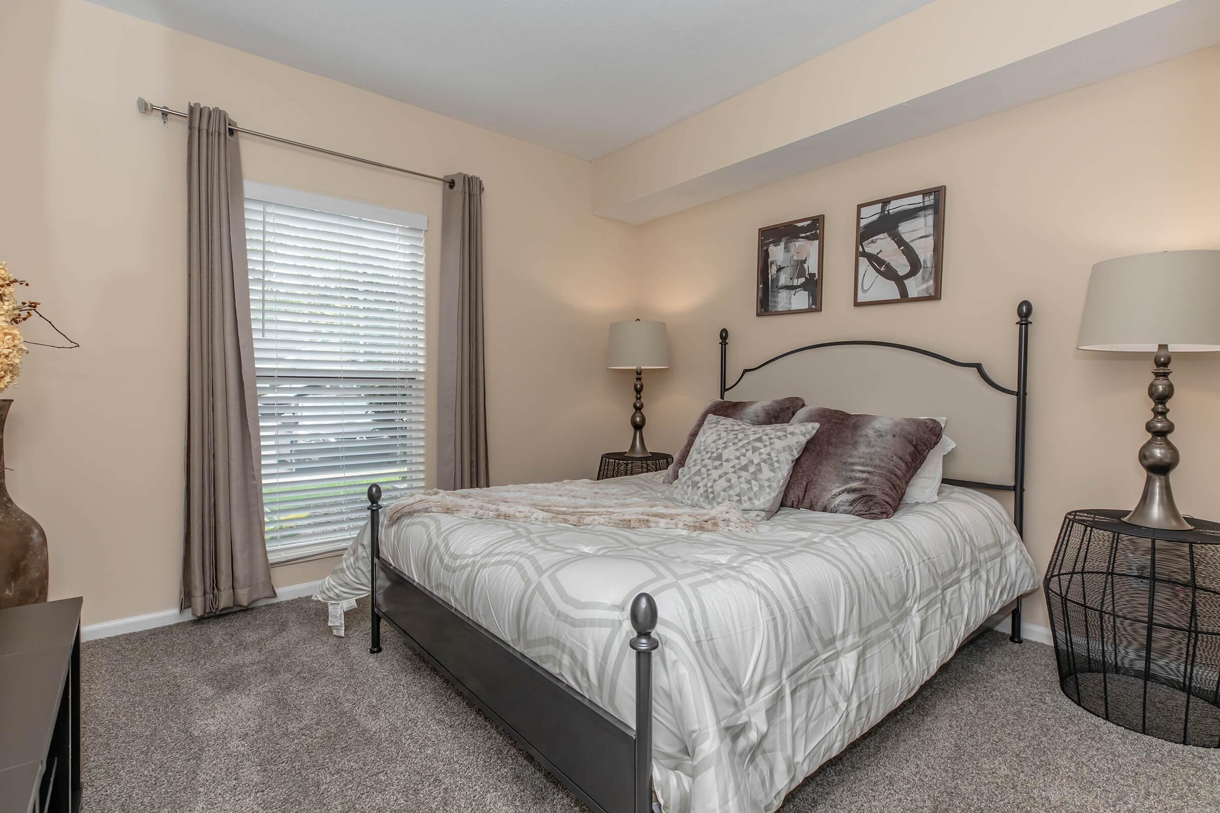 a bedroom with a large bed in a hotel room