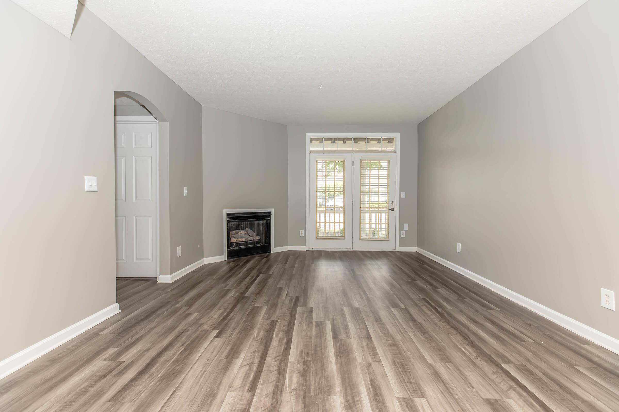 a large empty room with a wood floor