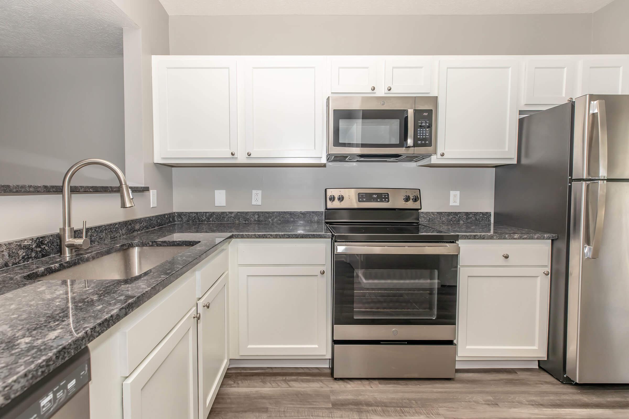 a kitchen with a stove and a microwave