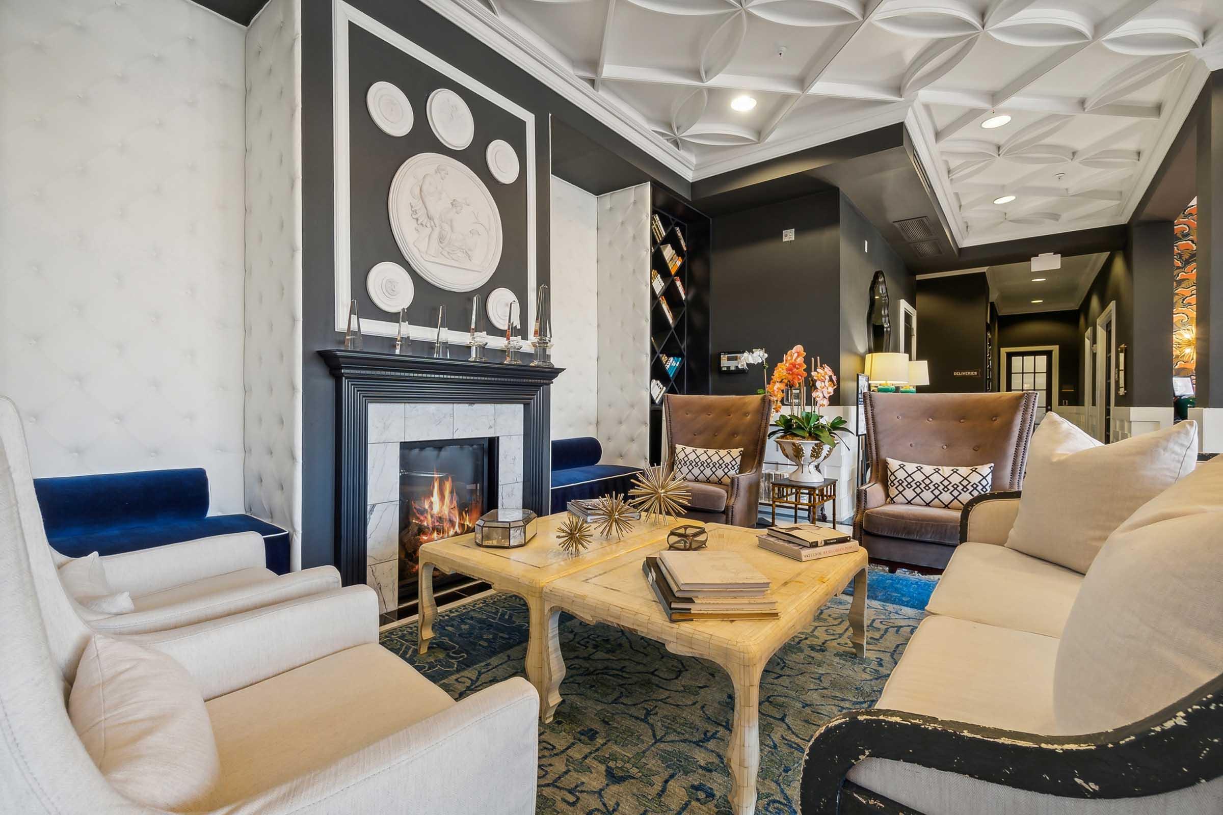 A stylish living room featuring a cozy fireplace, an elegant wooden coffee table with decorative items, and plush seating arrangements.