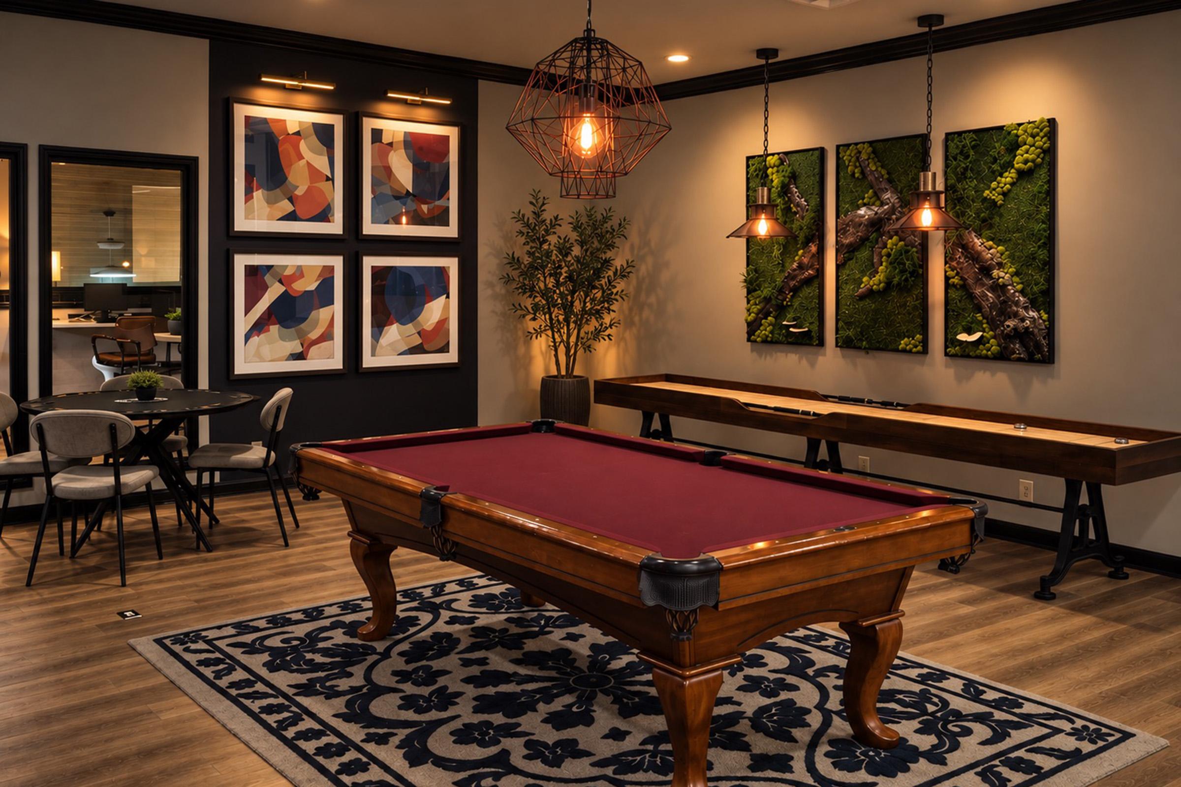 A stylish game room featuring a pool table with a maroon felt, surrounded by modern decor, including abstract wall art and greenery. Two pendant lights hang above the pool table, and a dining table with chairs is visible in the background on a patterned rug.