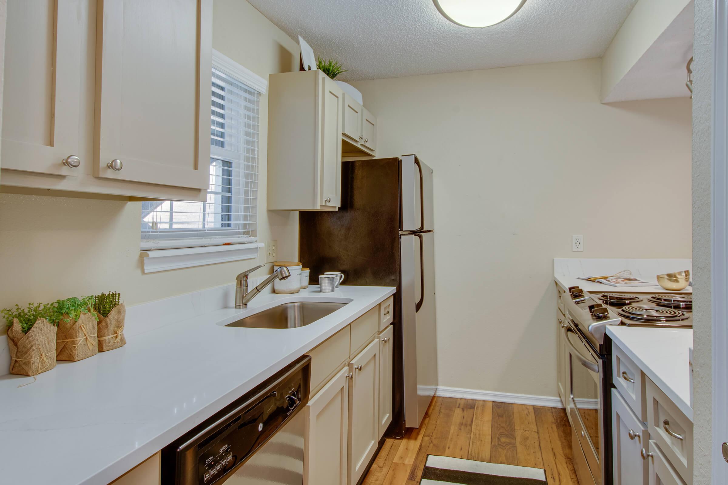 a kitchen with a sink and a mirror
