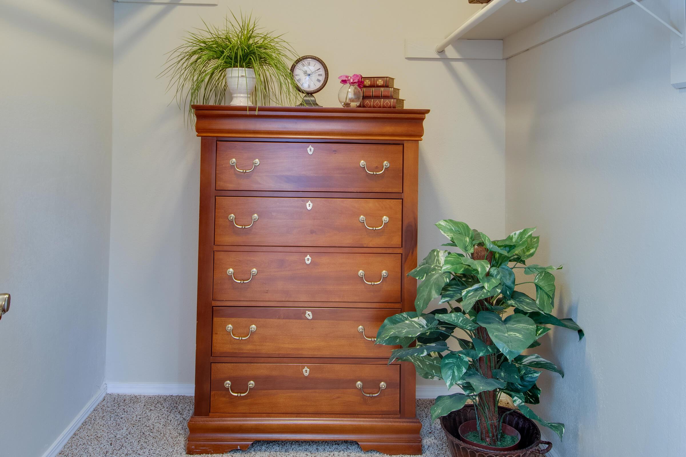 a clock sitting on top of a wooden cabinet