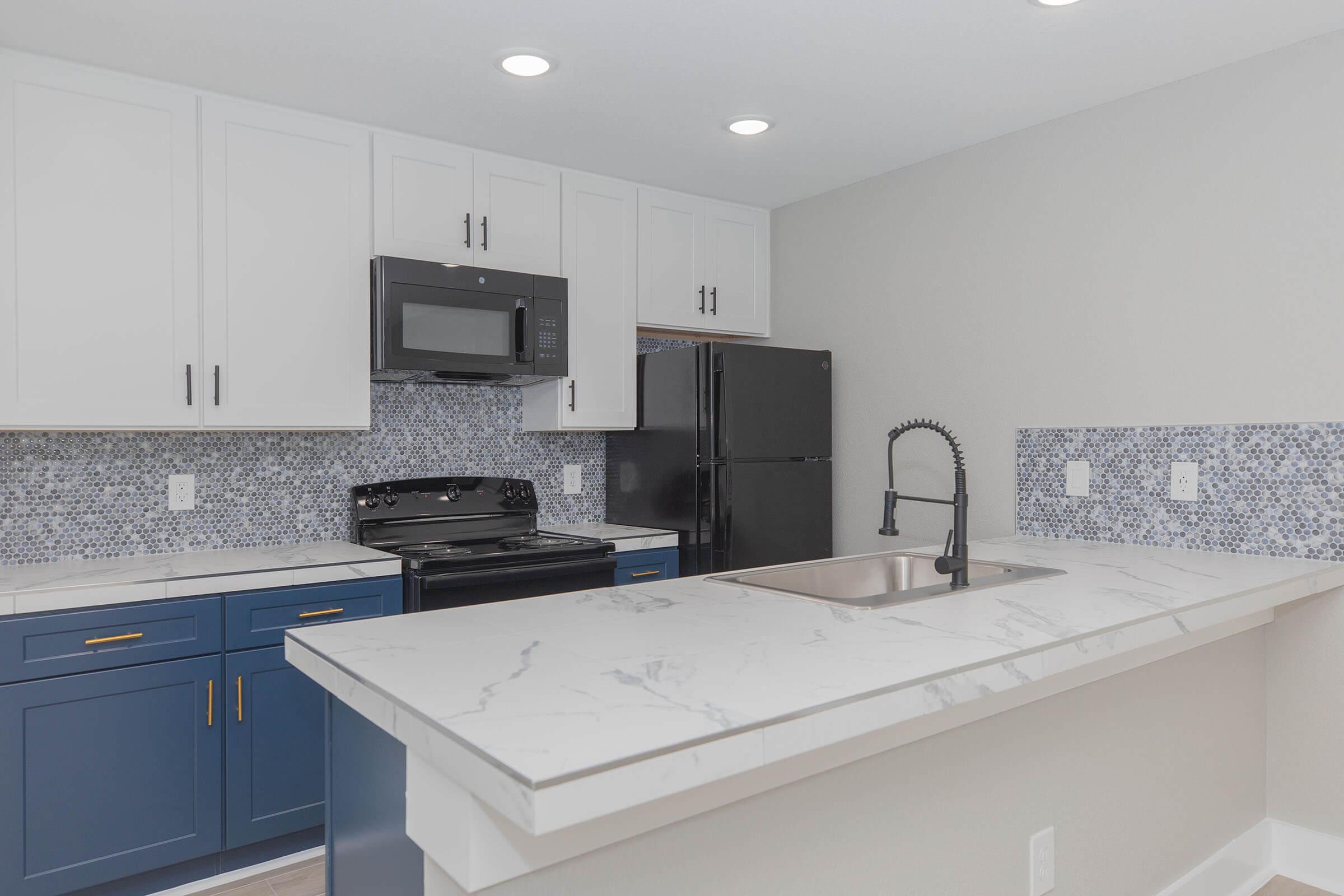 a kitchen with a sink and a mirror