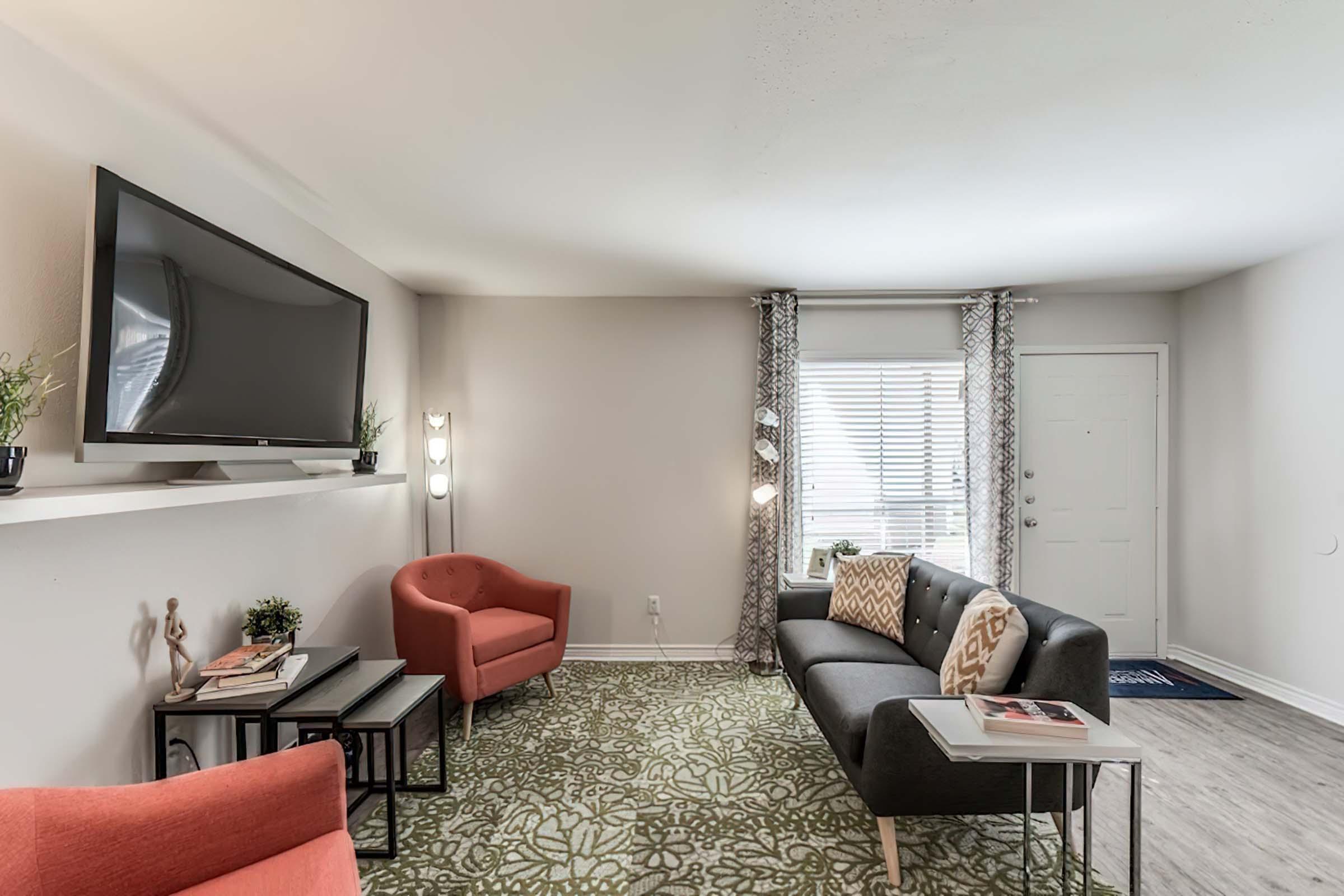 a living room filled with furniture and a large window