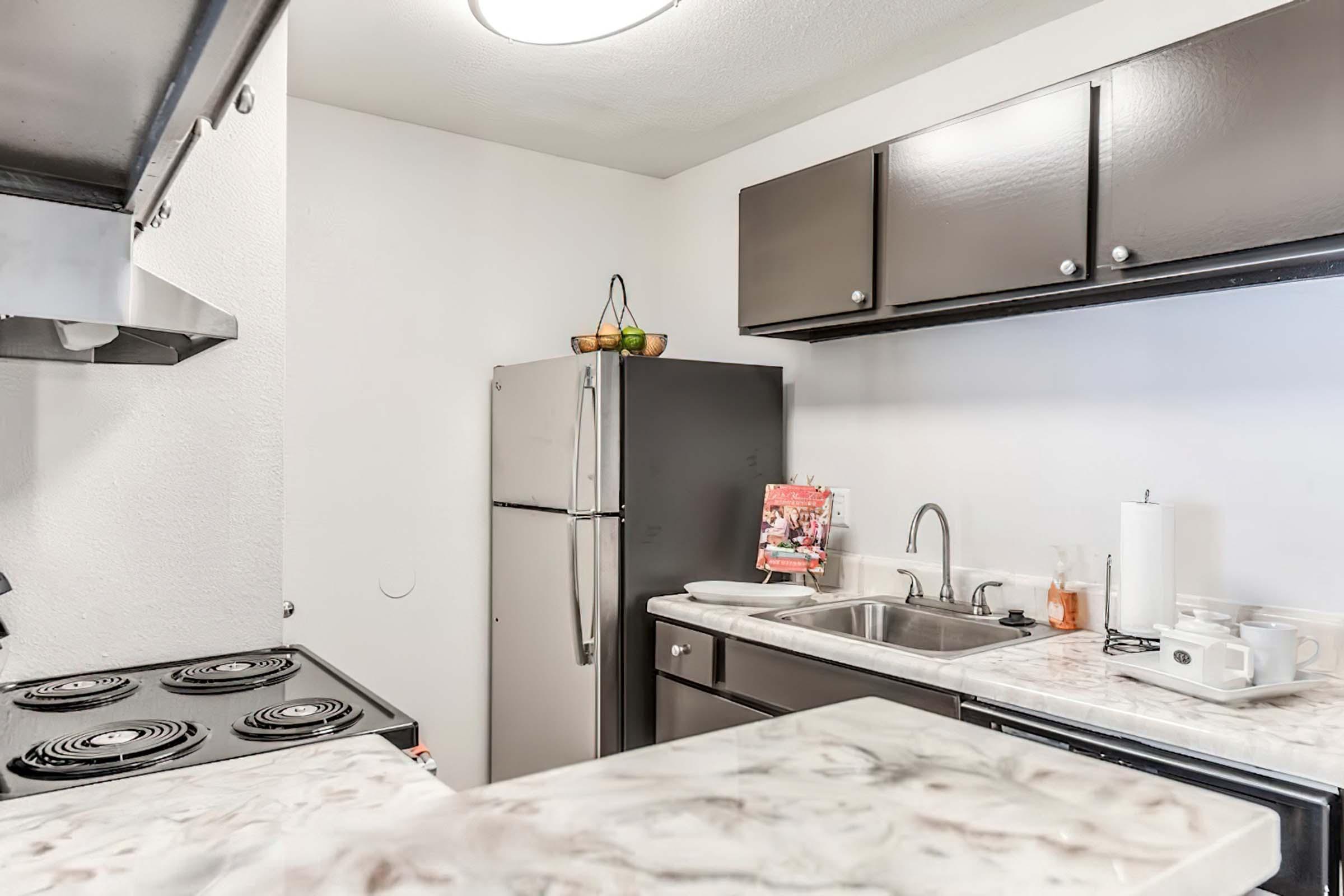 a kitchen with a sink and a mirror