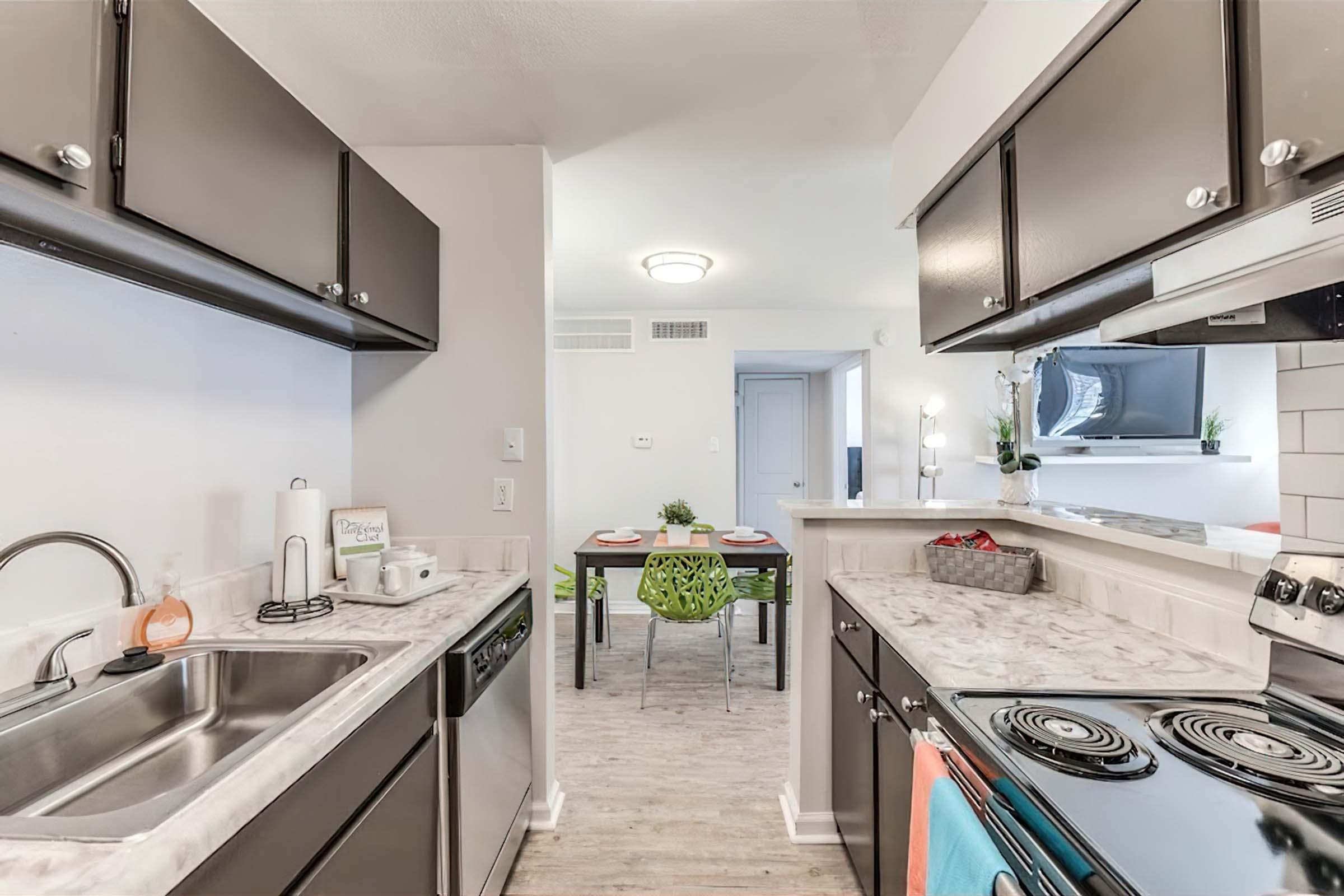 a kitchen with a sink and a counter in a room