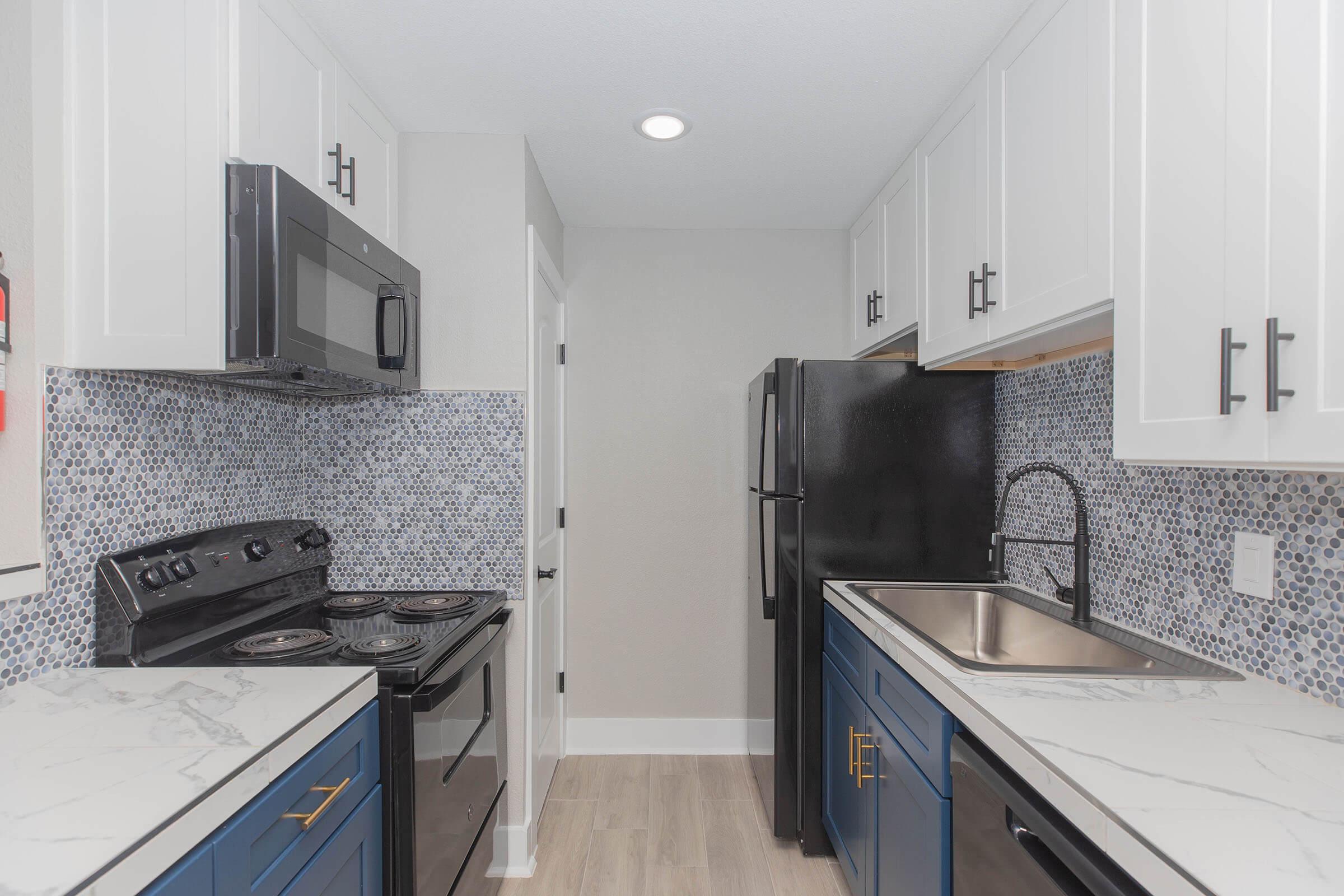 a kitchen with a stove sink and refrigerator