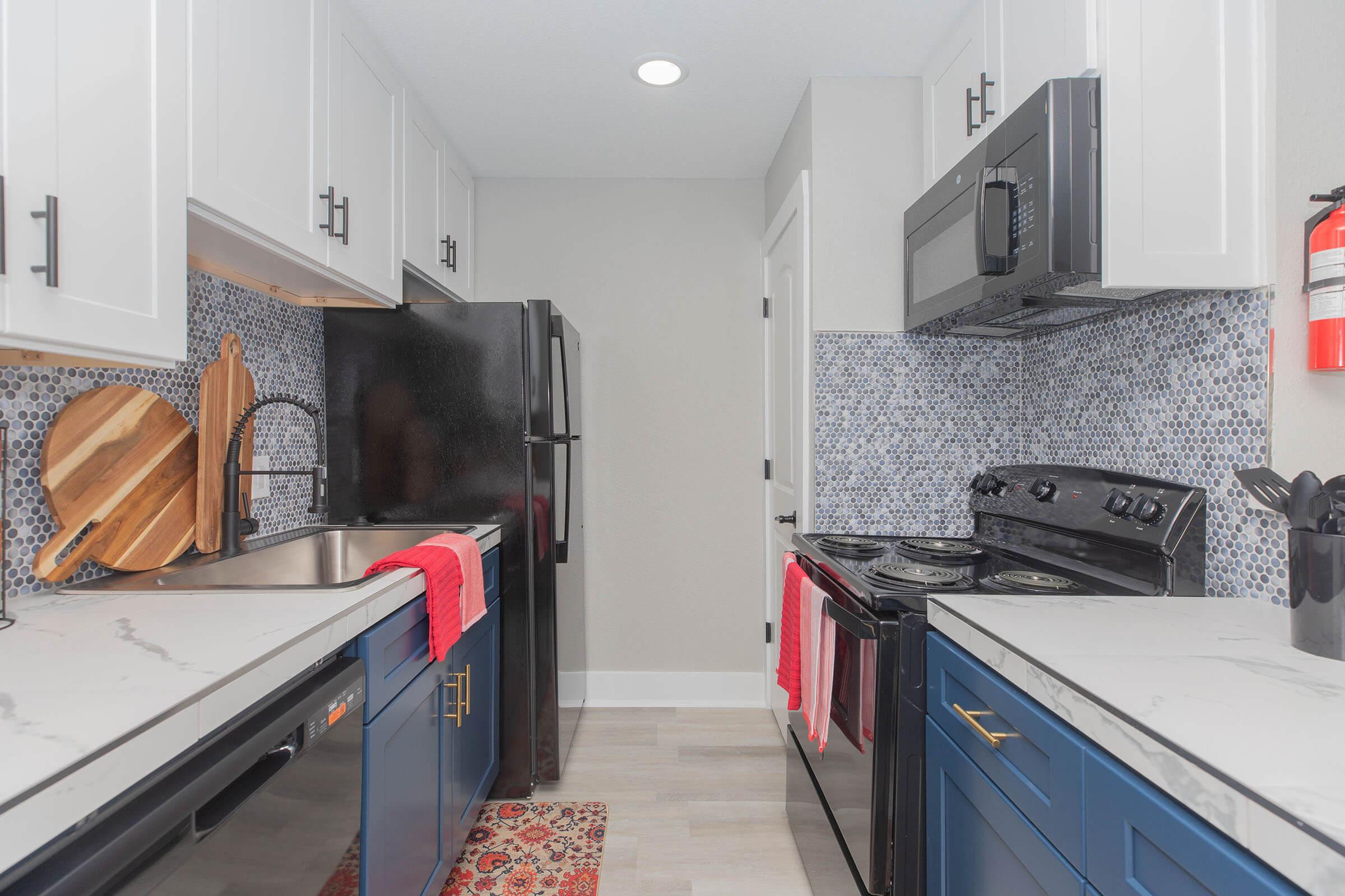 a kitchen with a stove sink and refrigerator