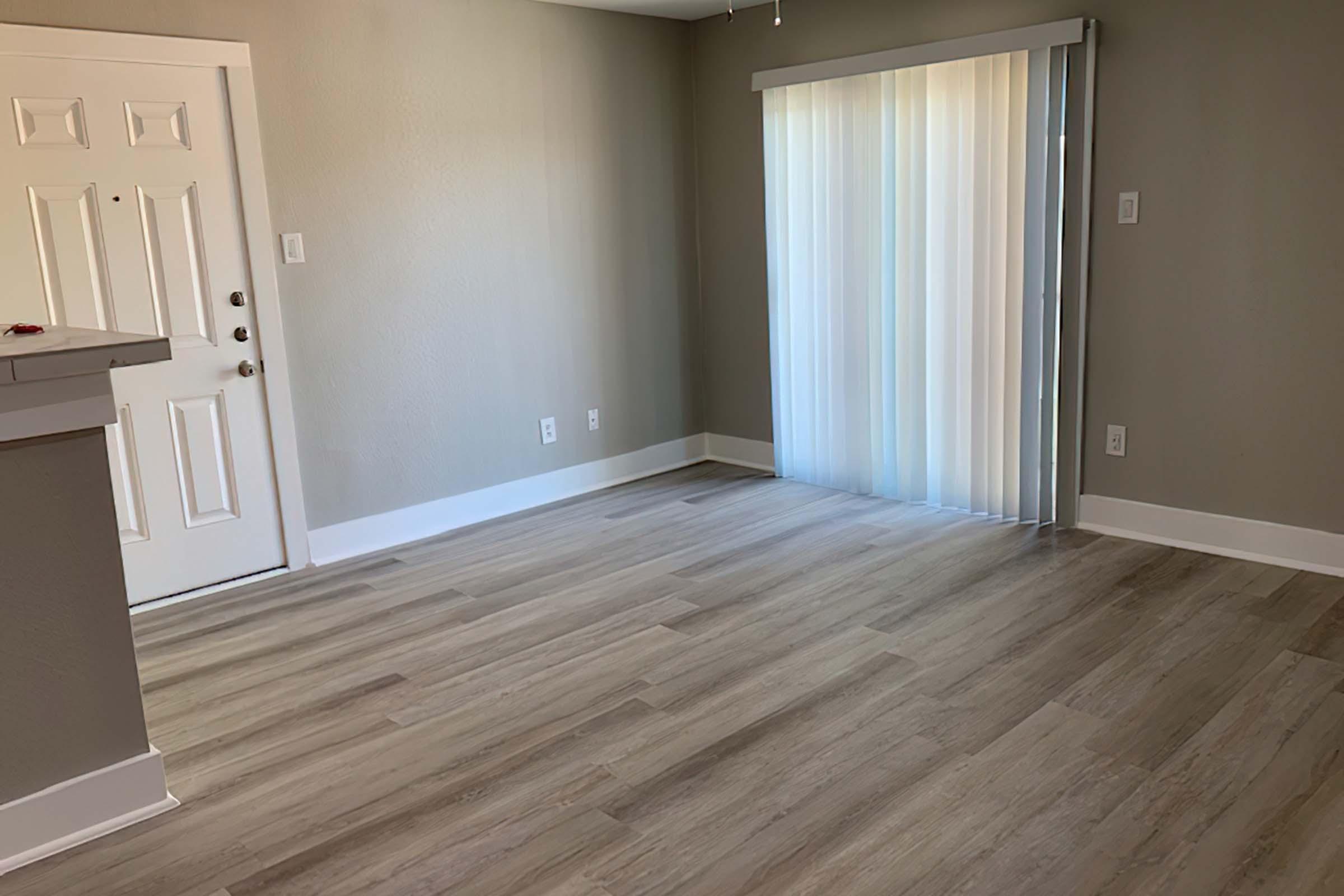 a large empty room with a wooden floor