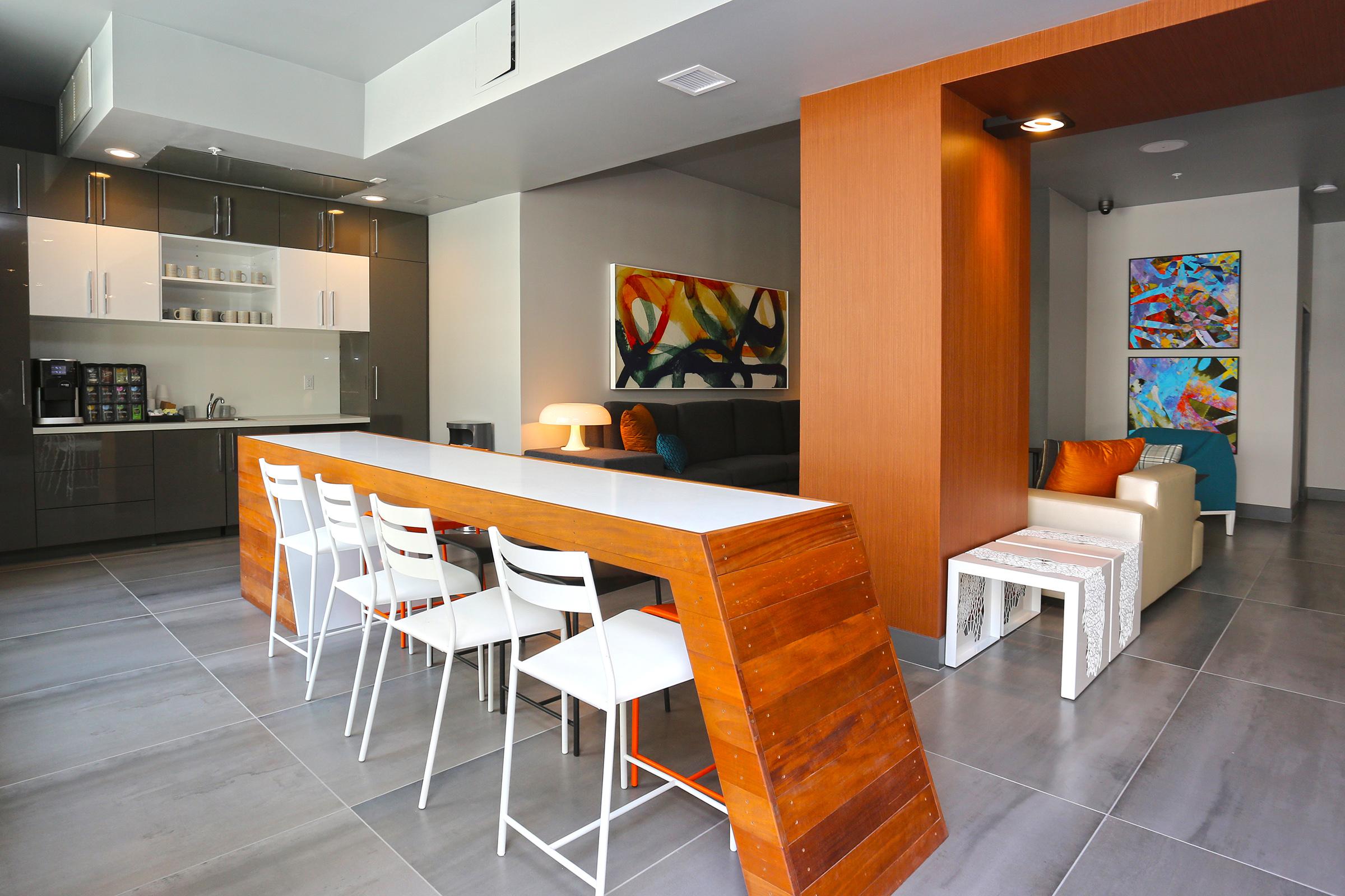 a clubhouse with a kitchen and barstools