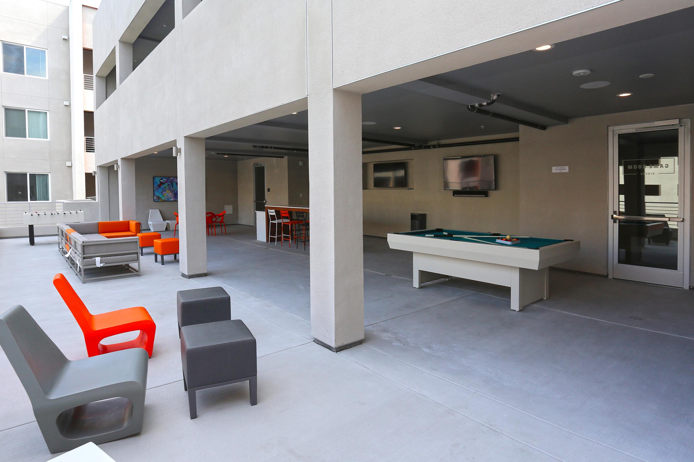 a patio area with seating and game tables