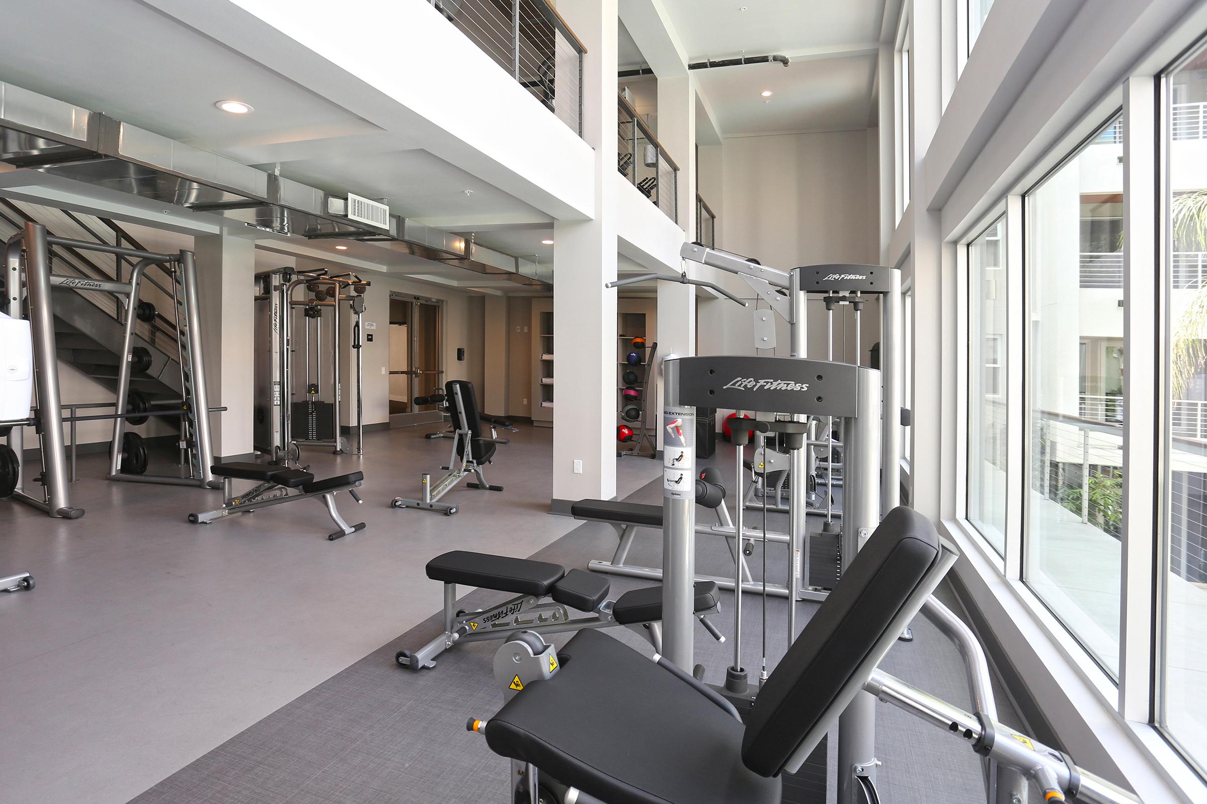 a gym filled with equipment and a large window