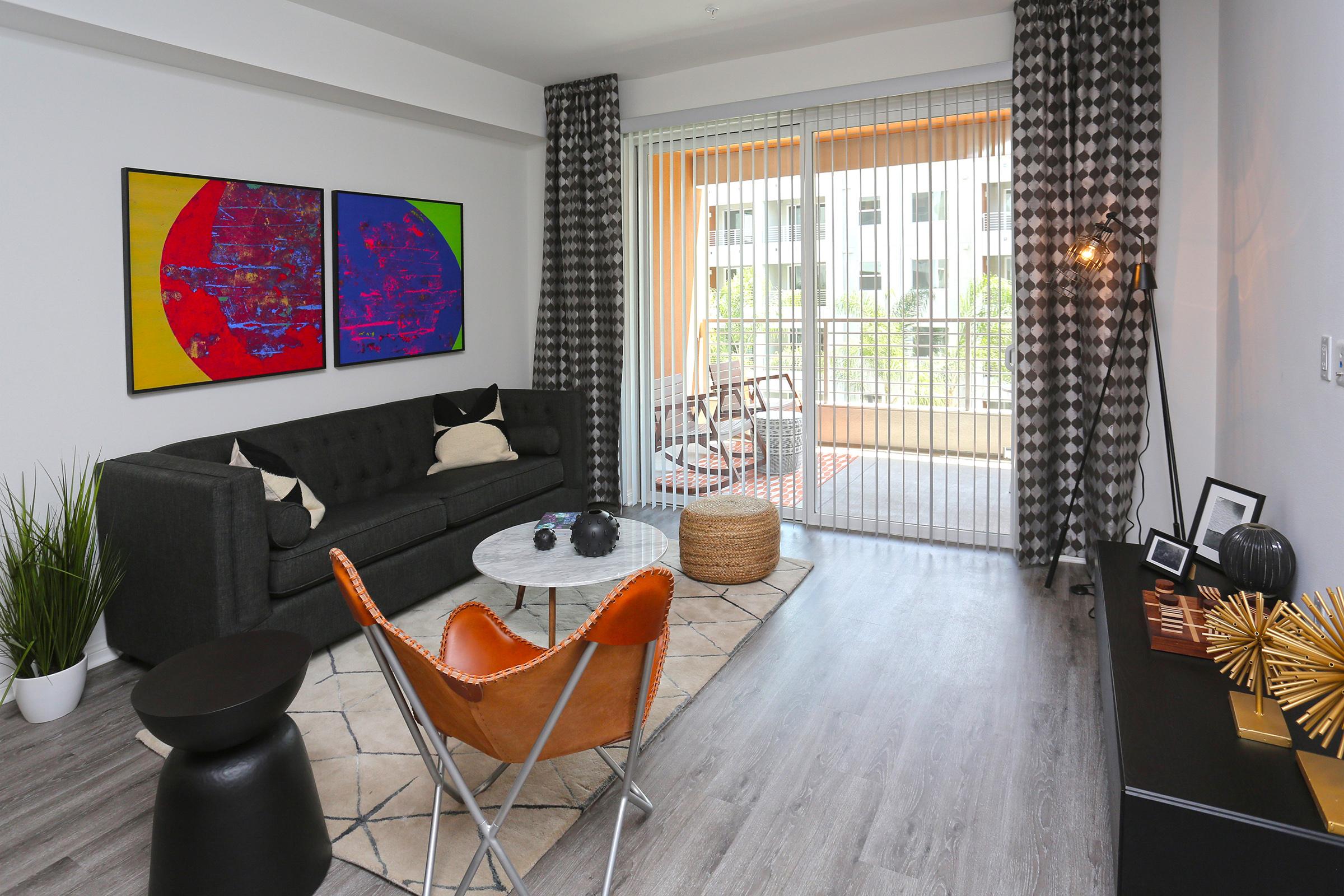 a living room filled with furniture and a large window