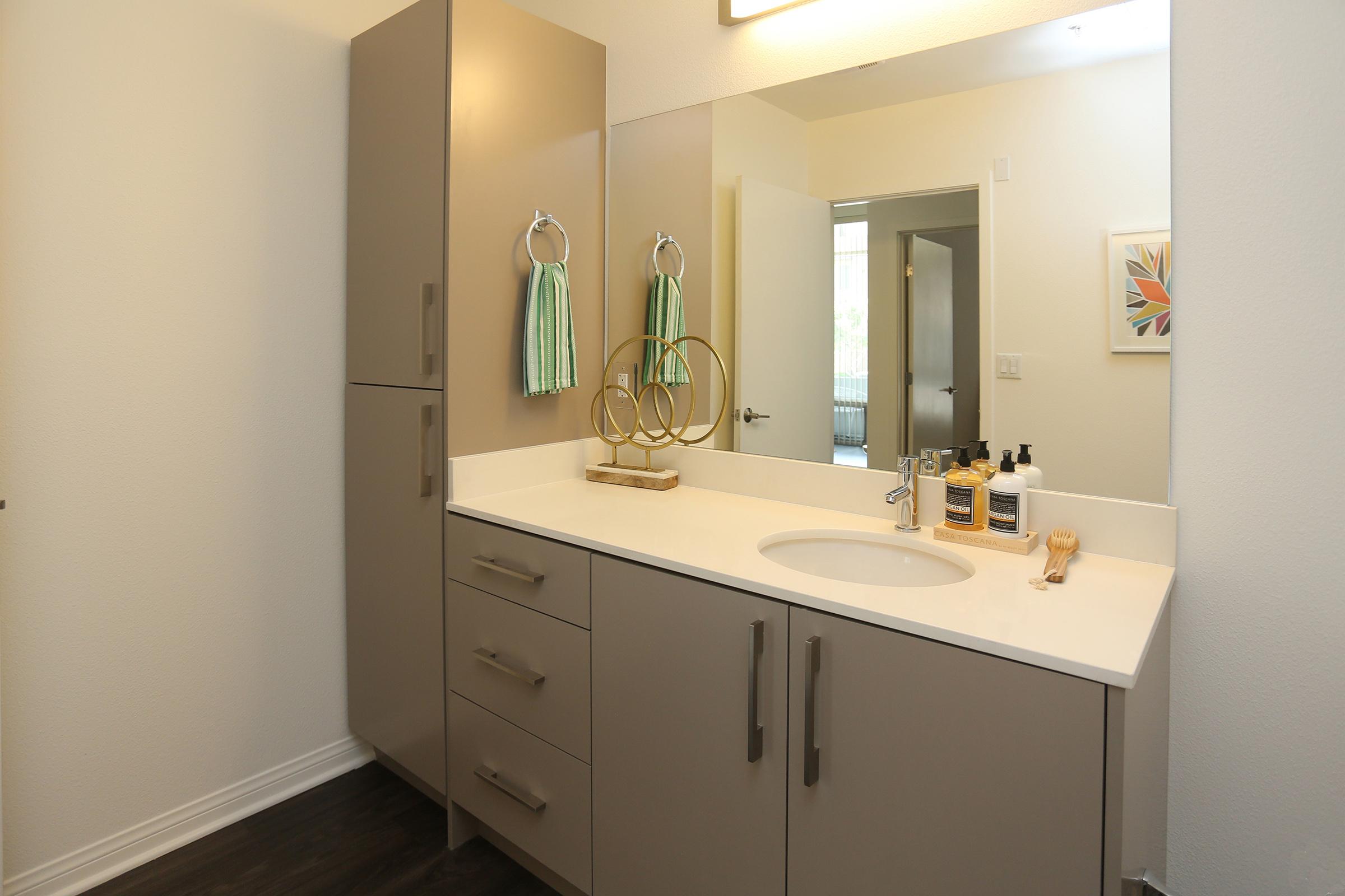 a vanity with a sink and a mirror