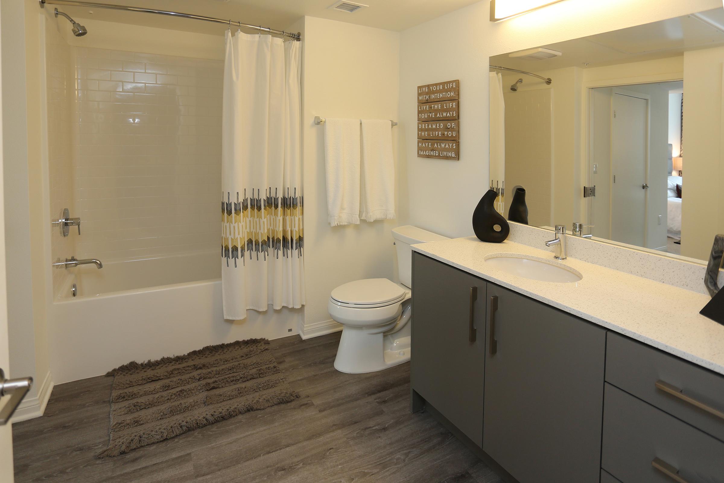 a bathroom with a tub and a mirror