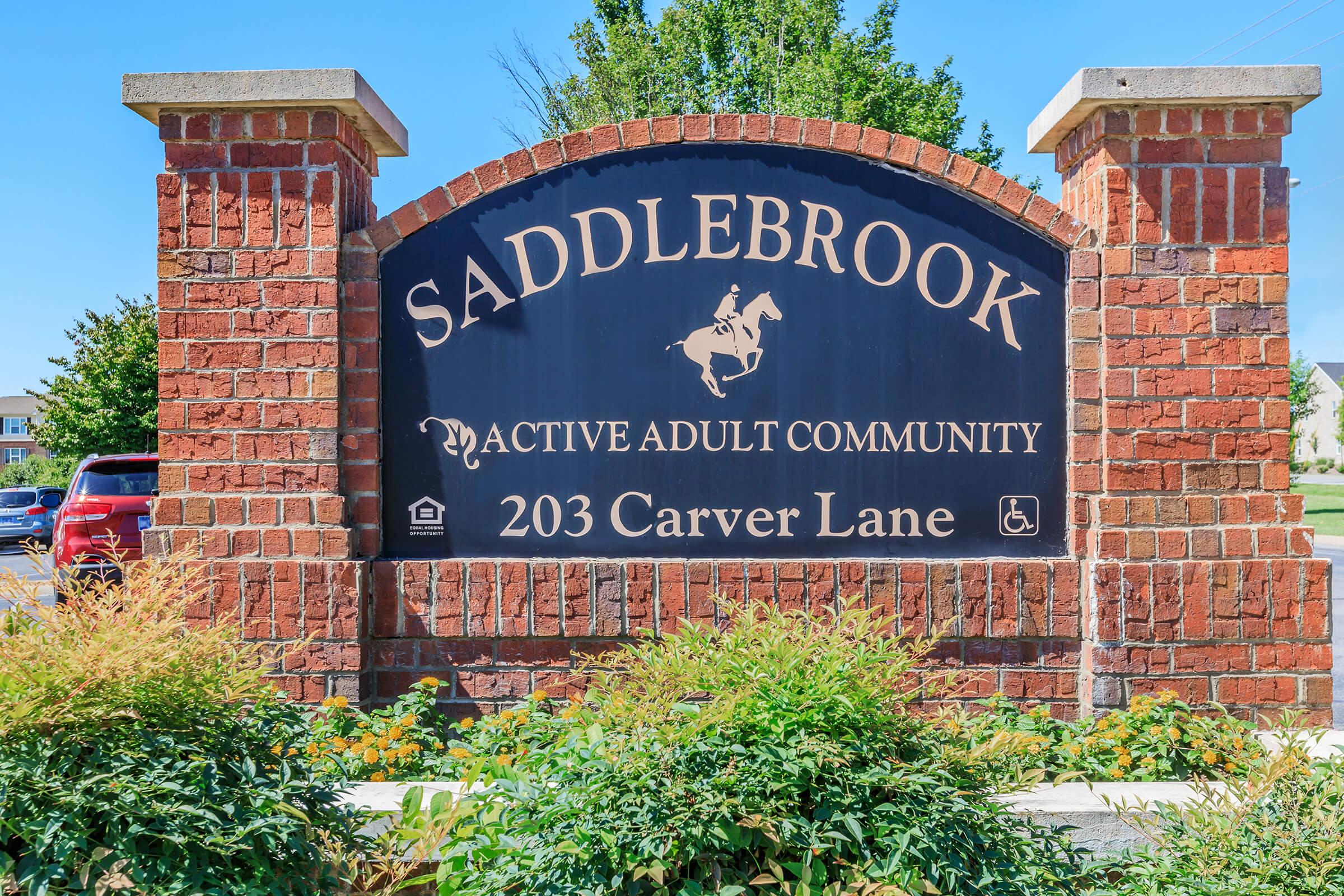 a sign in front of a brick building