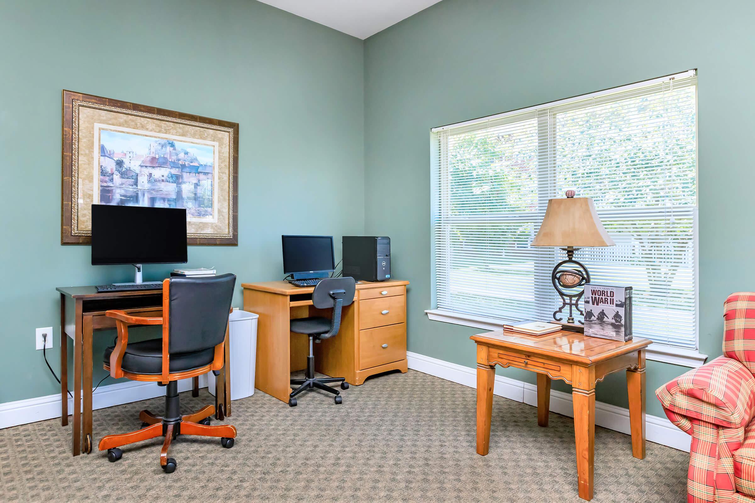 a bedroom with a desk and chair in a room