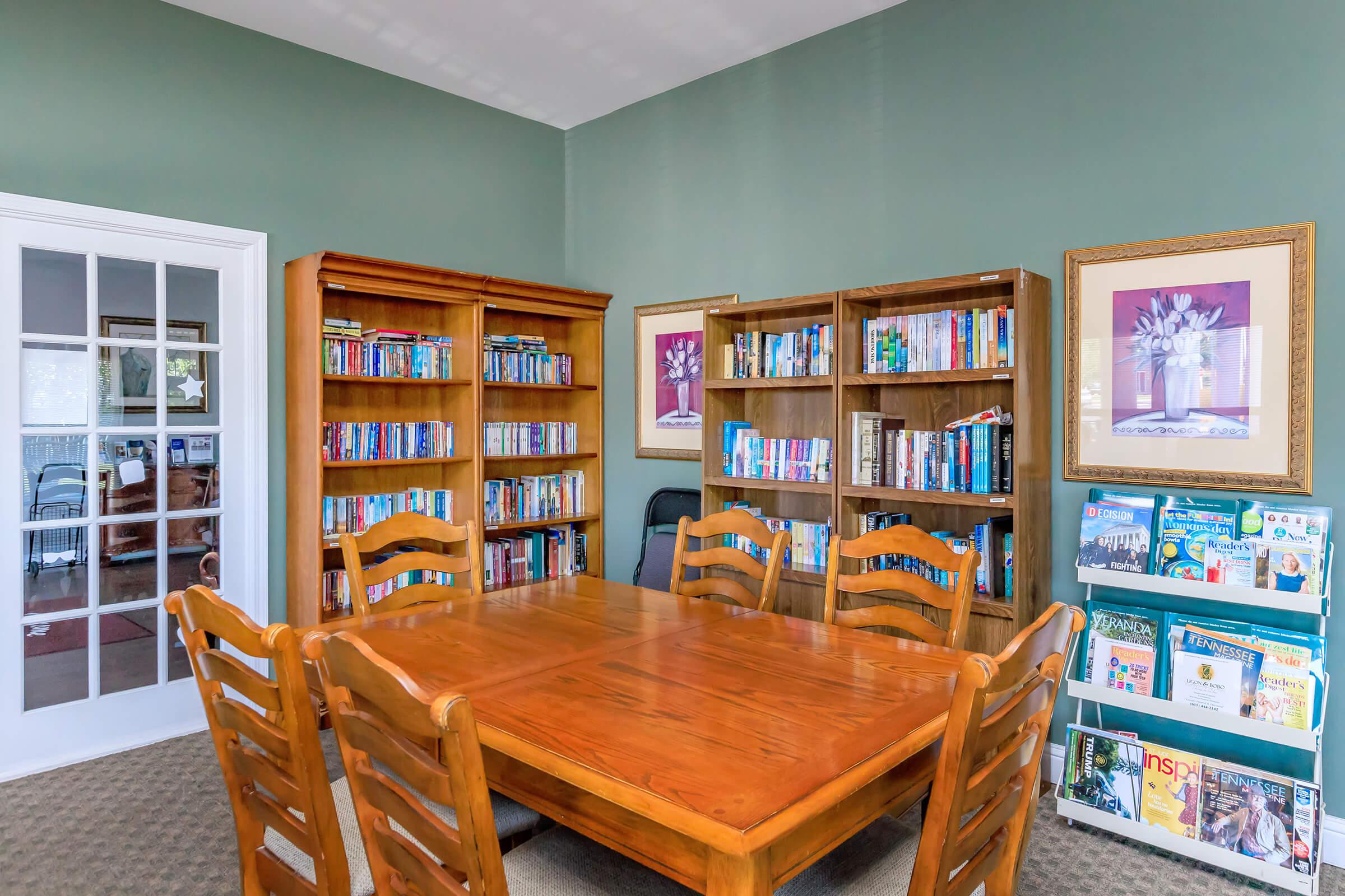 a dining room table and chairs in a library