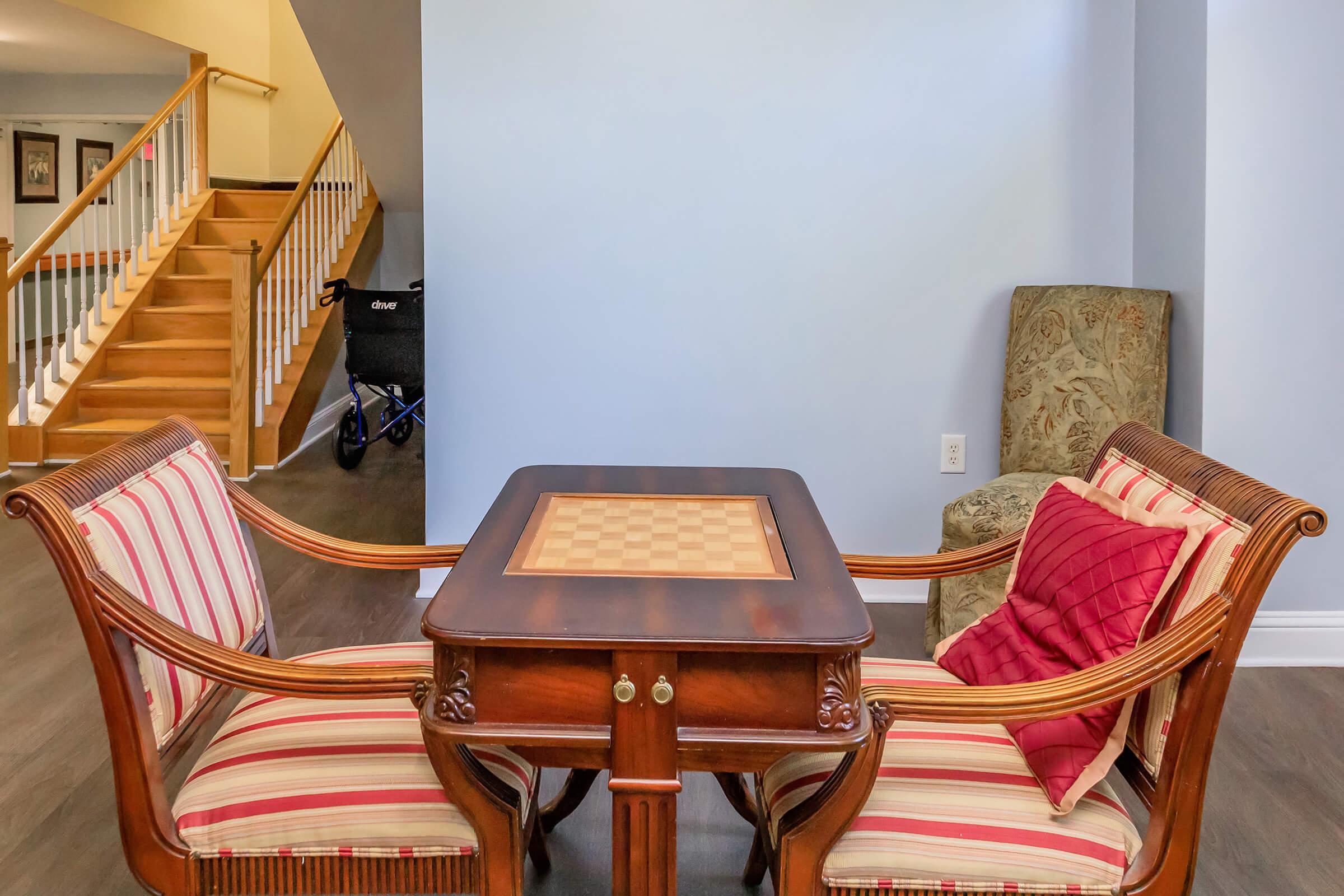 a chair sitting in front of a wooden table