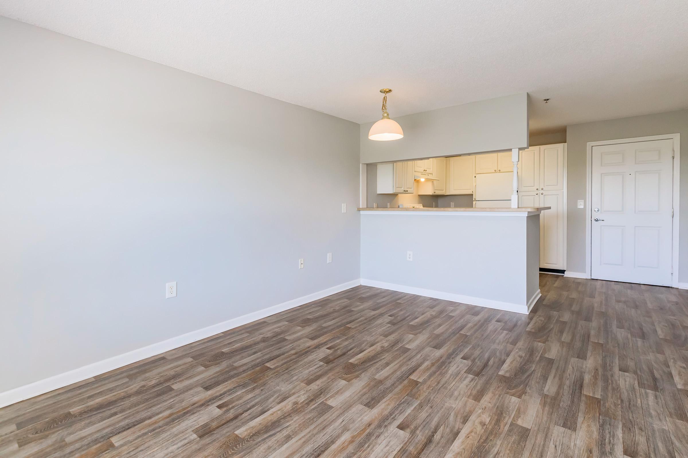 a large empty room with a wooden floor