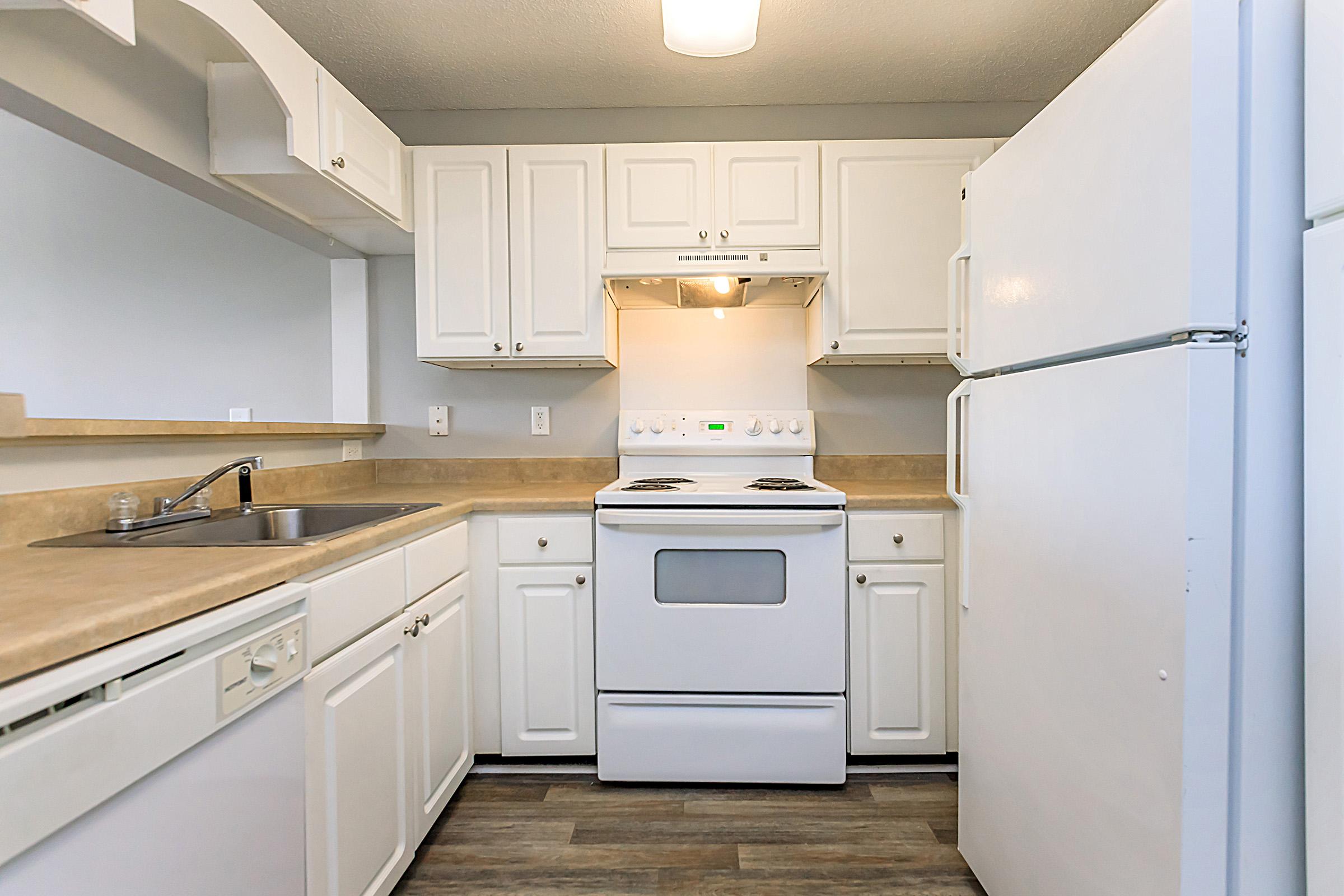 a kitchen with a stove and a refrigerator