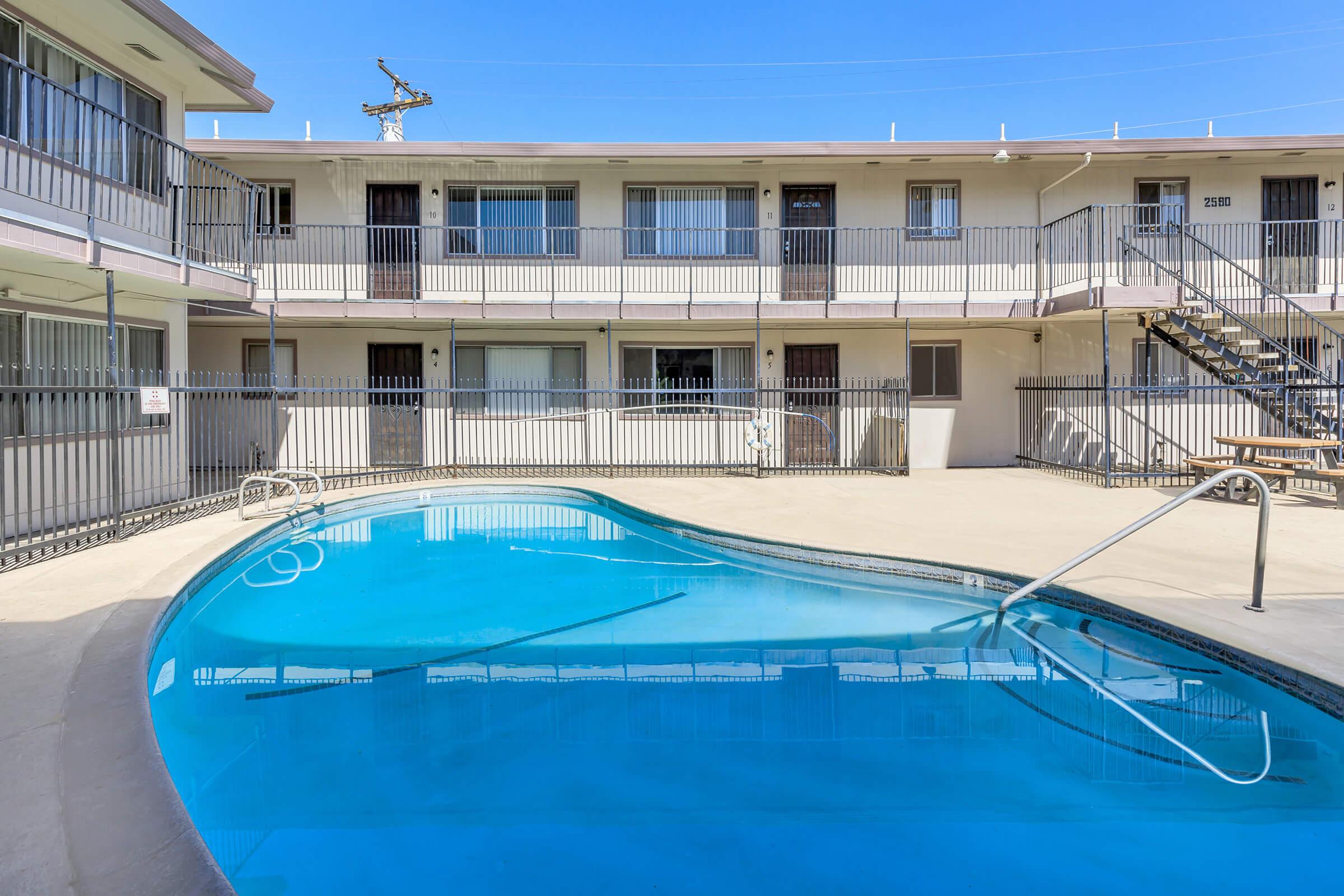 a blue pool of water in front of a building