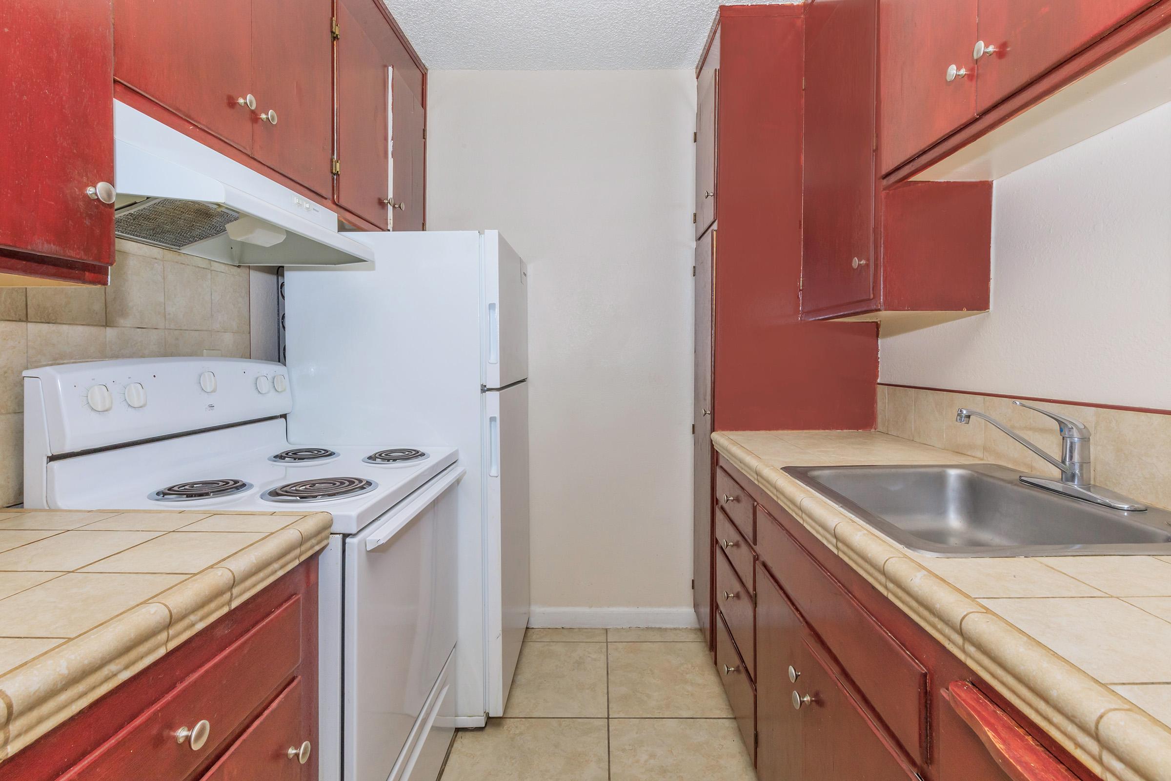 a kitchen with a stove sink and refrigerator