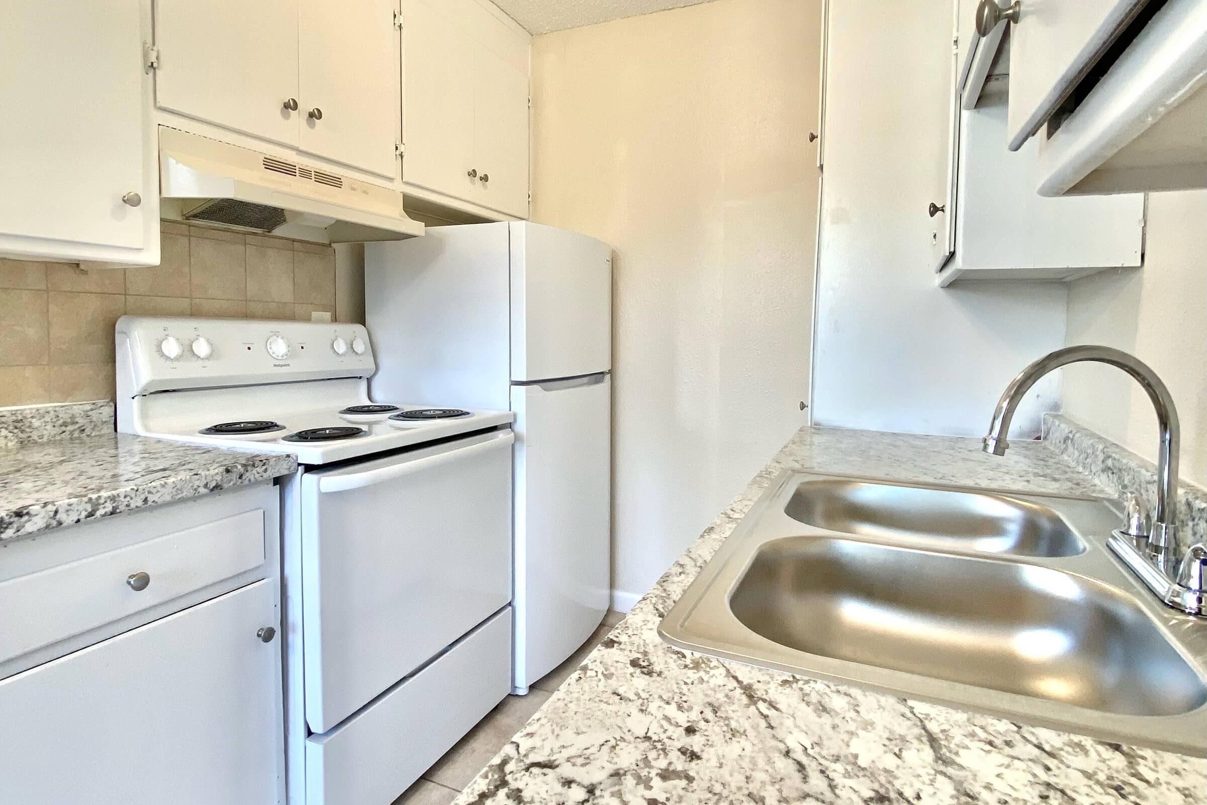 a stove top oven sitting inside of a kitchen