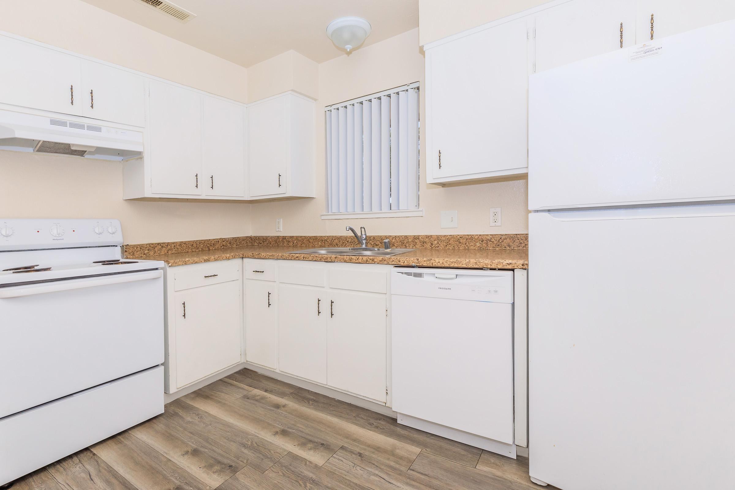 a kitchen with a stove and a refrigerator