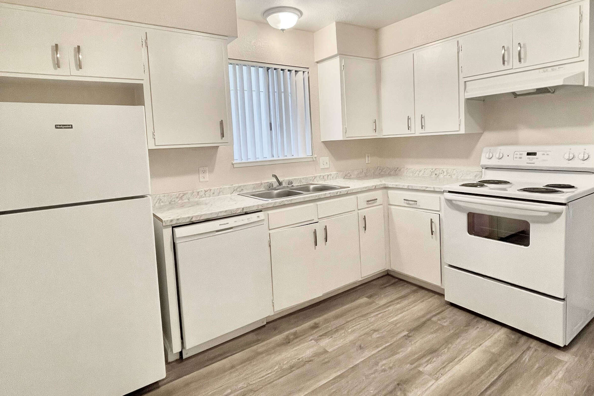 a kitchen with a stove and a refrigerator