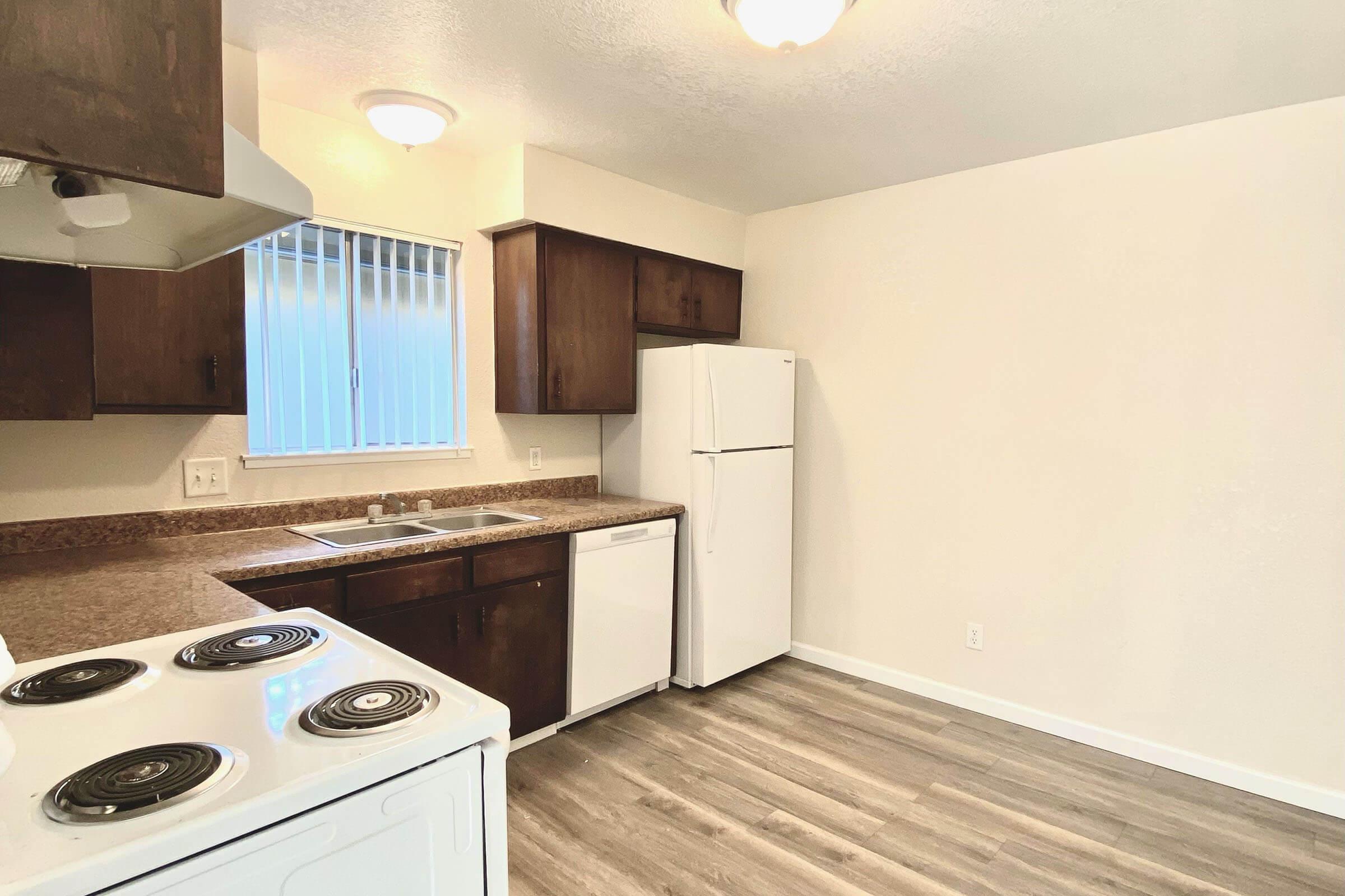 a stove top oven sitting inside of a kitchen