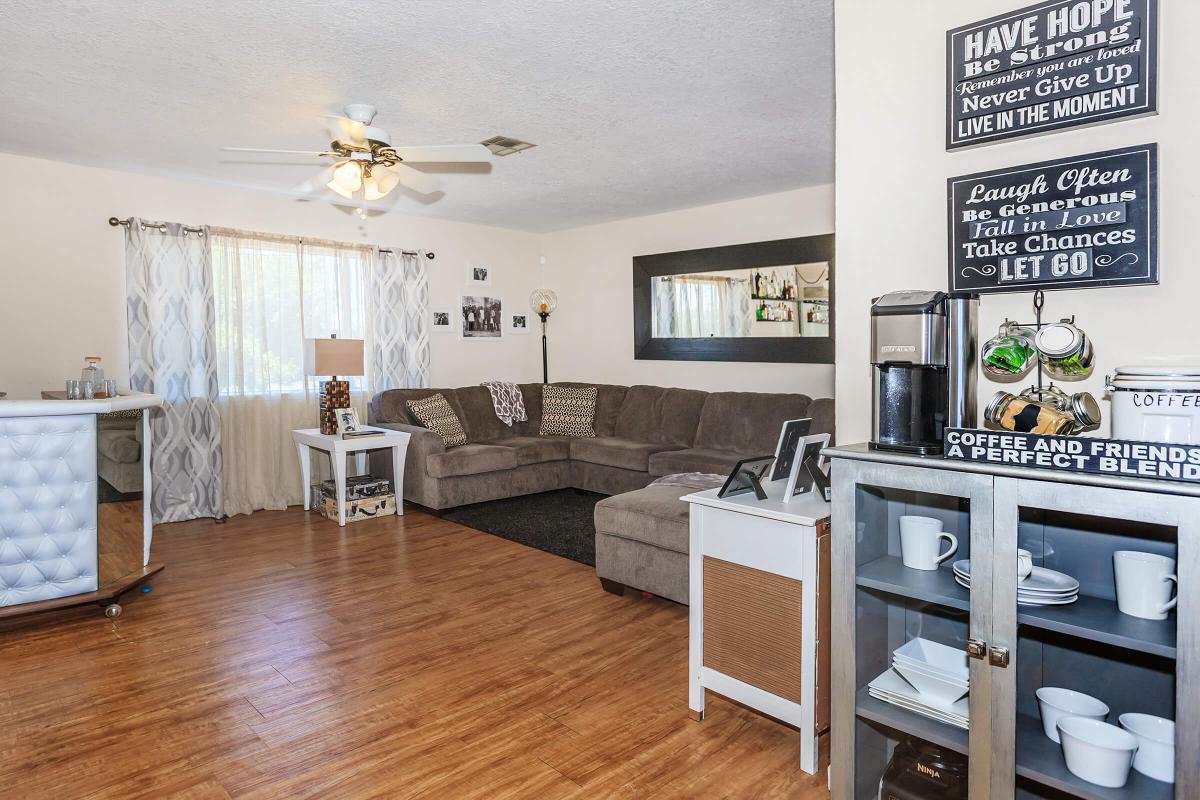 a living room filled with furniture and a wood floor