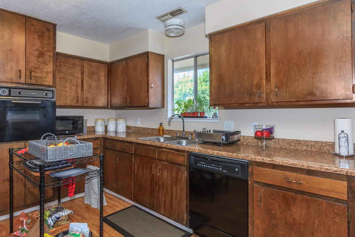 a kitchen with stainless steel appliances and wooden cabinets