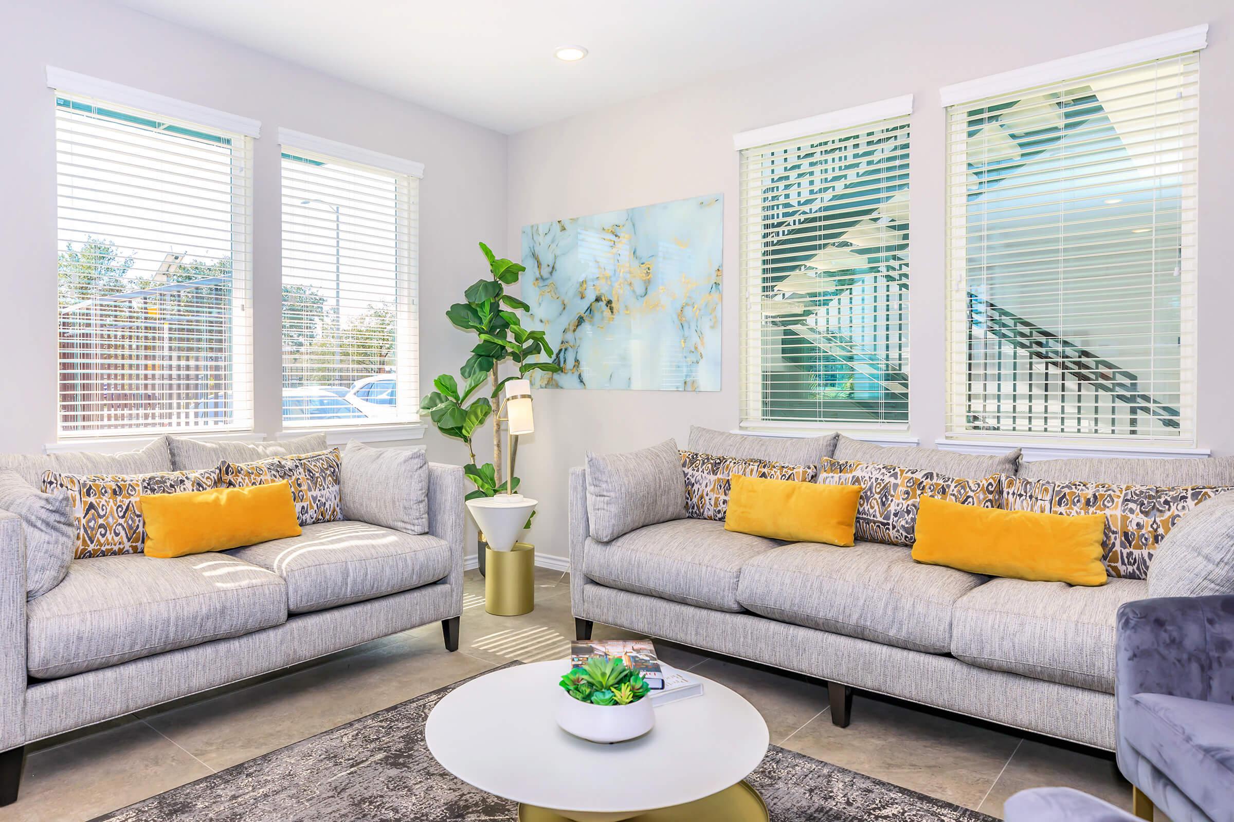 a living room filled with furniture and a flat screen tv