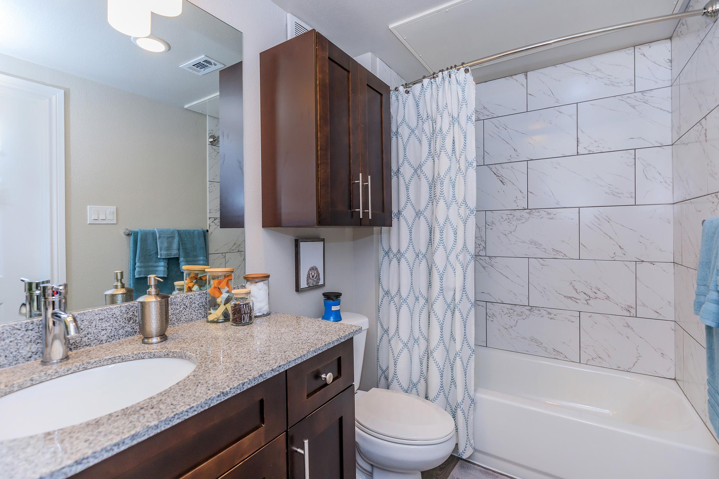 a kitchen with a sink and a mirror