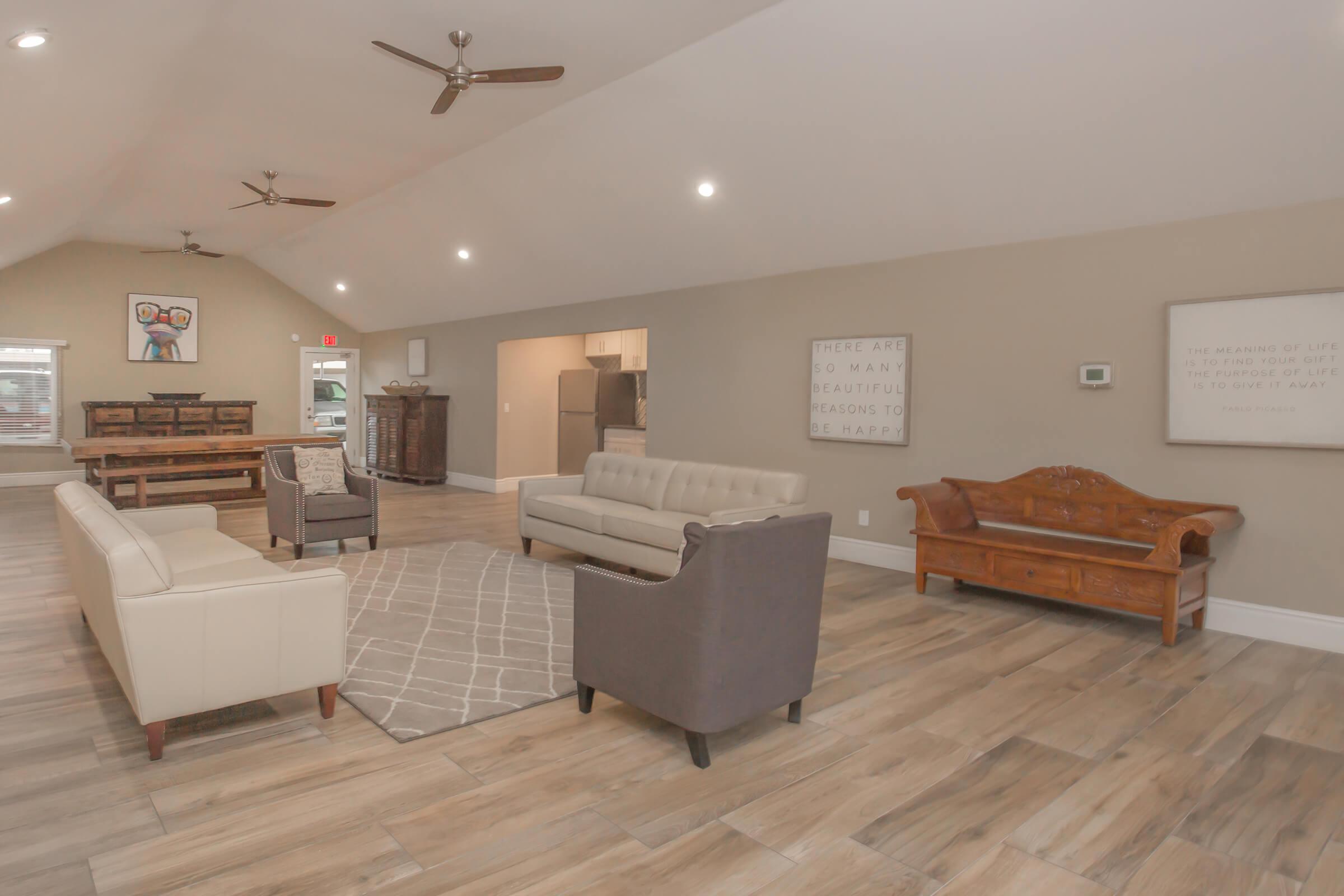 a living room filled with furniture and a wood floor