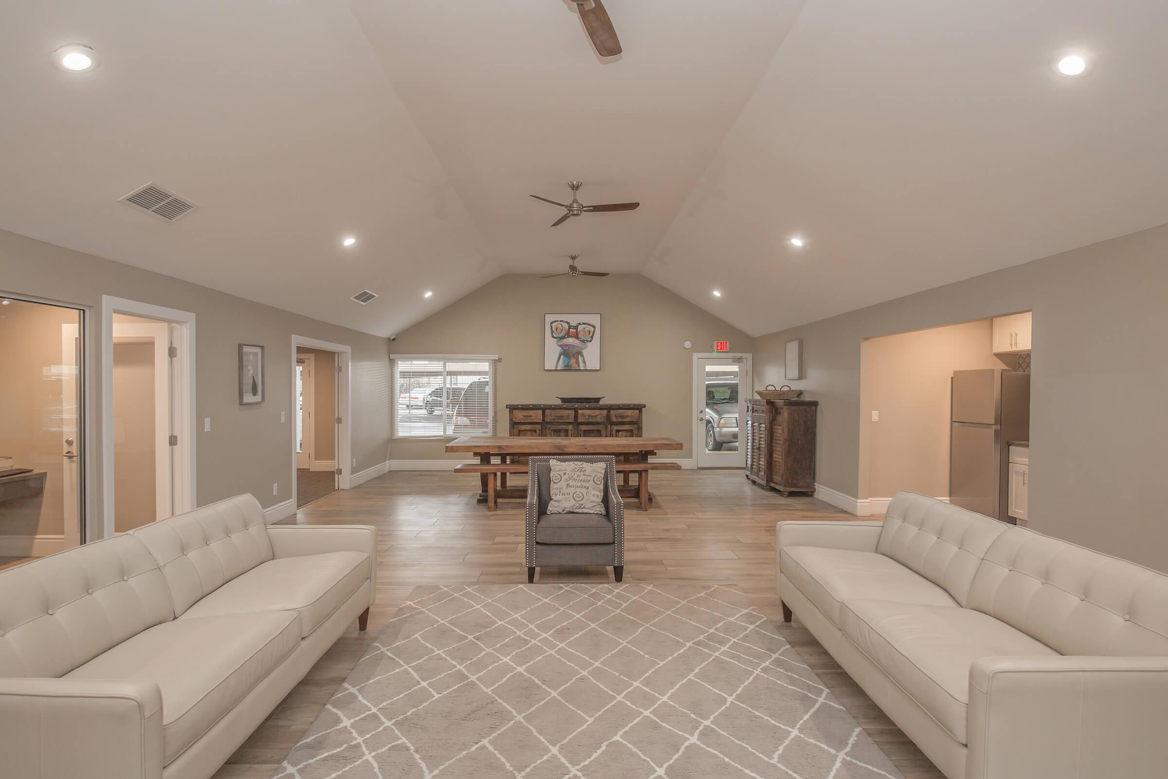 a living room filled with furniture and a large mirror